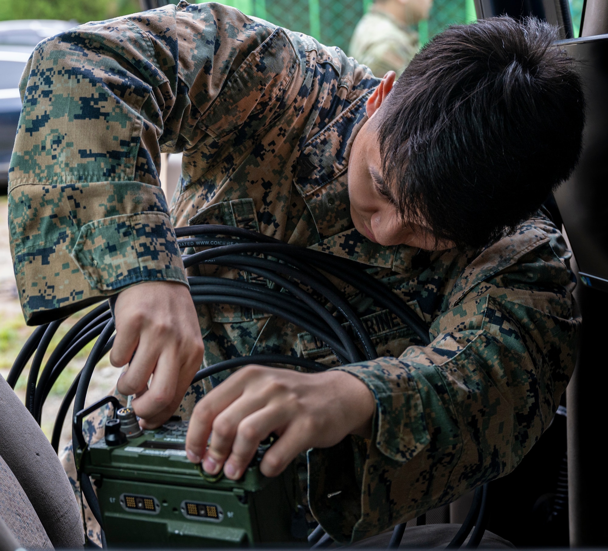 U.S Marine Corps. Sgt. Jaden Mensalvas, 621st Air Control Squadron intelligence analyst, installs an ultra high frequency radio in a mobile tactical command and control (C2) vehicle at Yongin Army Base, Republic of Korea, Aug. 31, 2022.