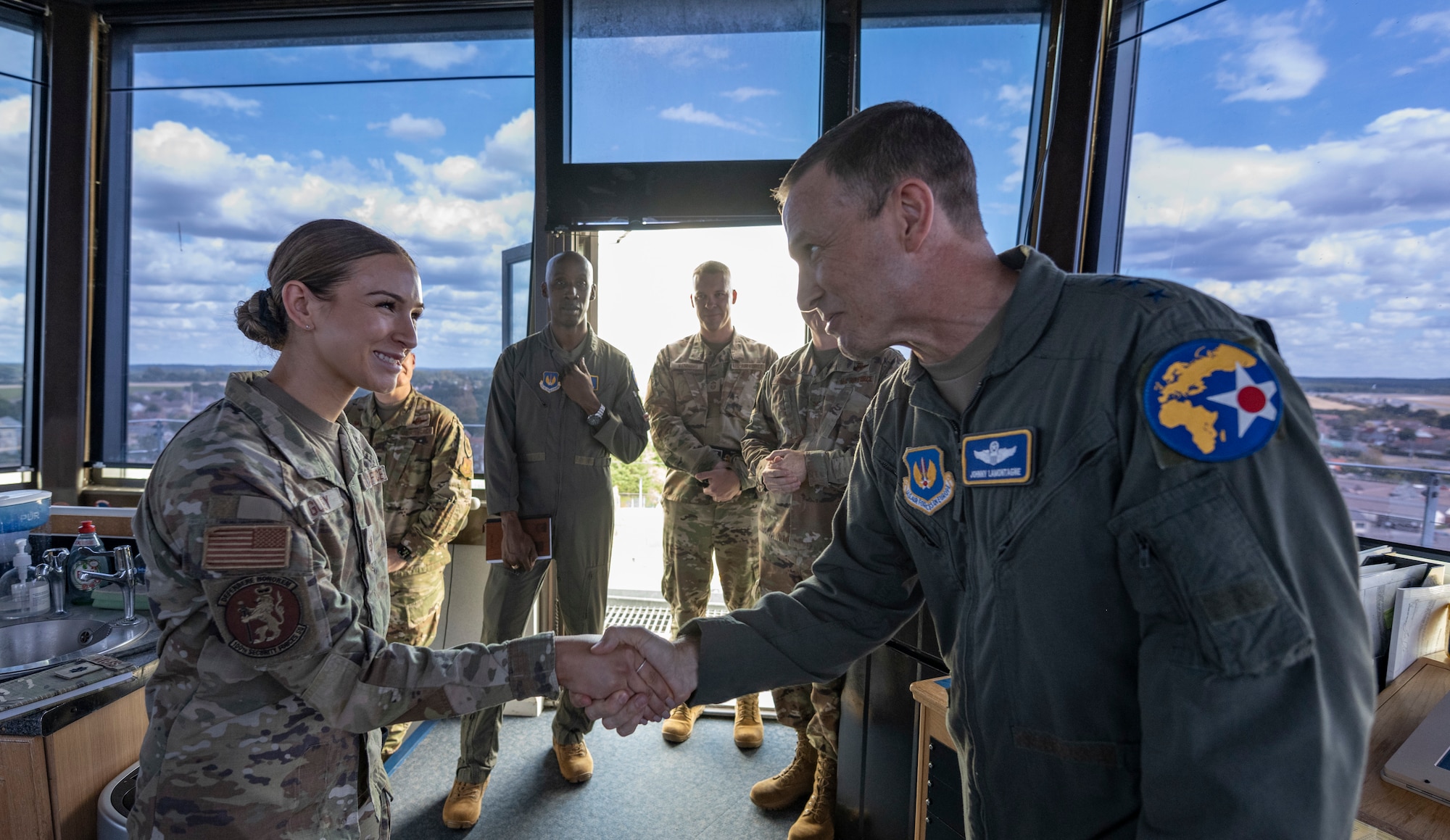 U.S. Air Force Lt. Gen. John D. Lamontagne awards a coin for superior performer to Staff Sgt. Sadie Gulley