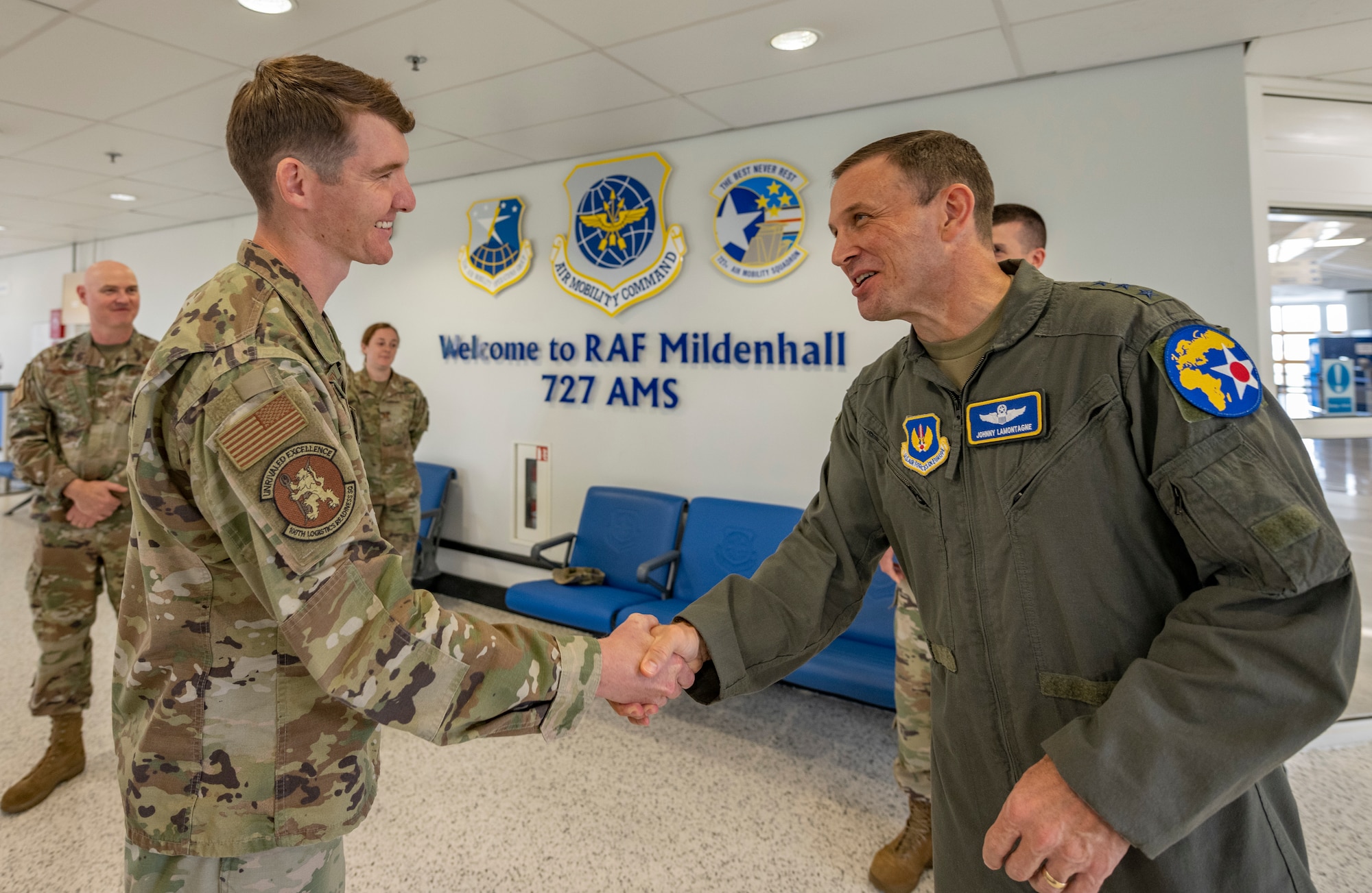 U.S. Air Force Lt. Gen. John D. Lamontagne awards a coin for superior performer to Capt. Cole Finnerty