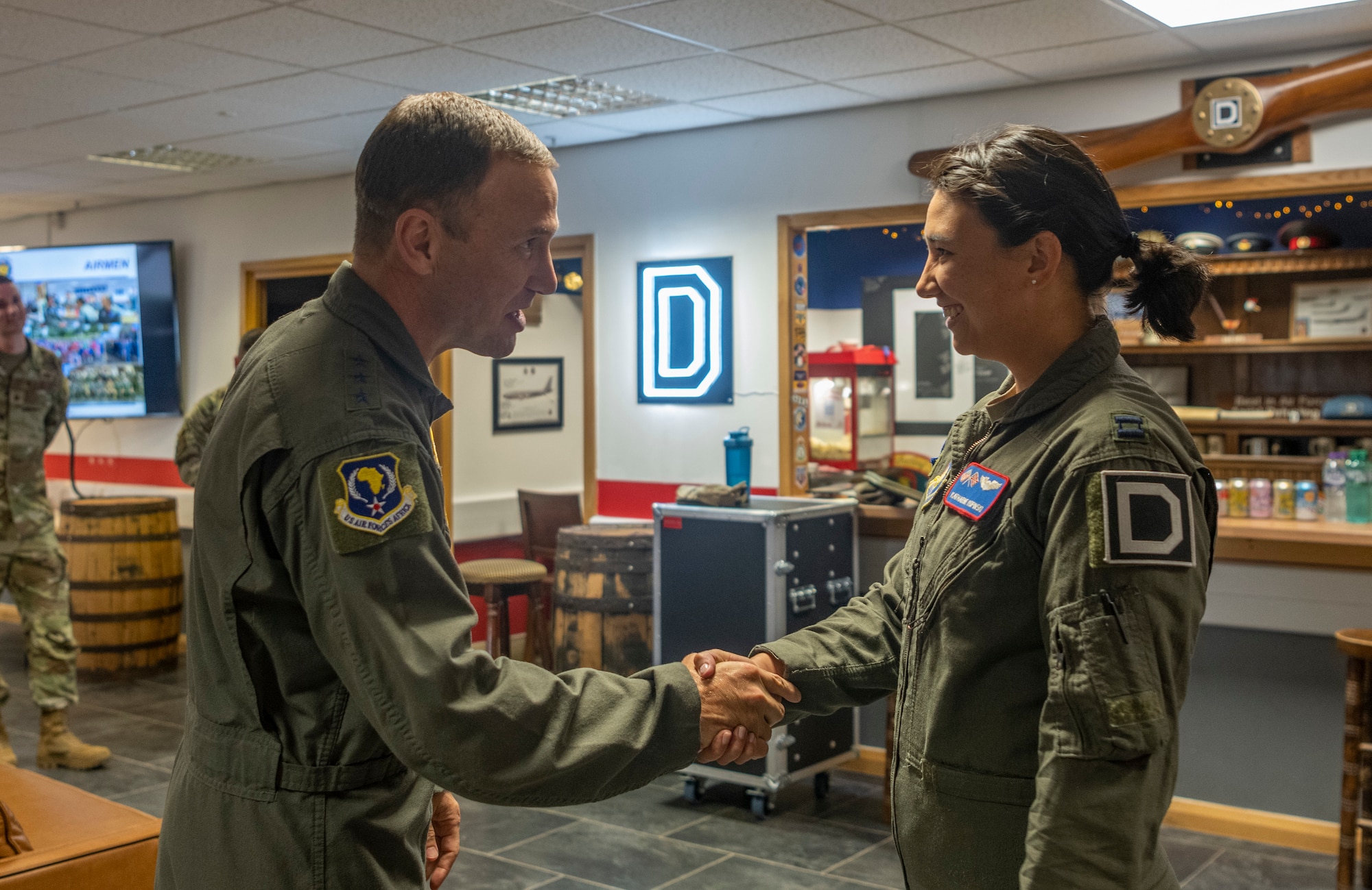 U.S. Air Force Lt. Gen. John D. Lamontagne awards a coin for superior performer to Capt. Katherine Kopinski