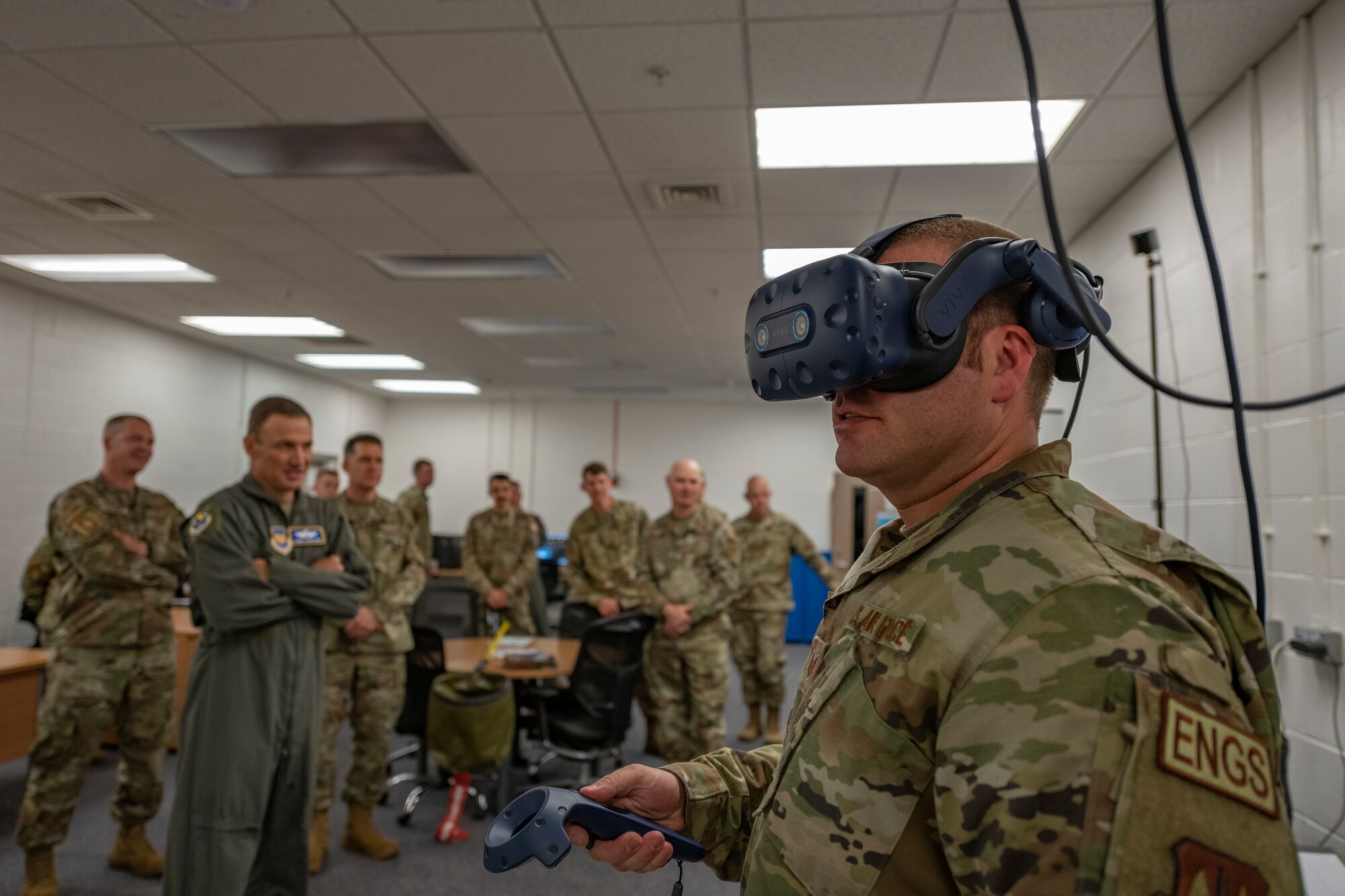 U.S. Air Force Tech Sgt. Nicholas Wilberger demonstrates the VR training course to Lt. Gen. John D. Lamontagne