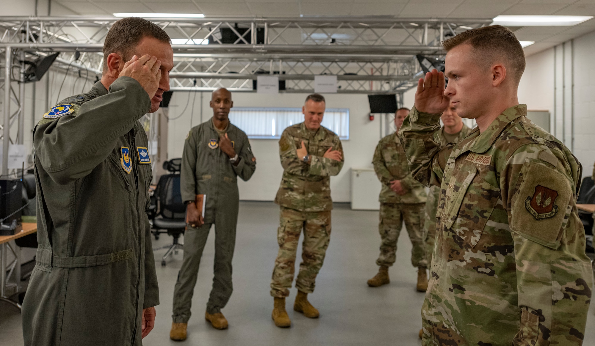 U.S. Air Force Lt. Gen. John D. Lamontagne, U.S. Air Forces in Europe and Air Forces Africa deputy commander, awards a coin for superior performer to Airman 1st Class Jacob Helzer