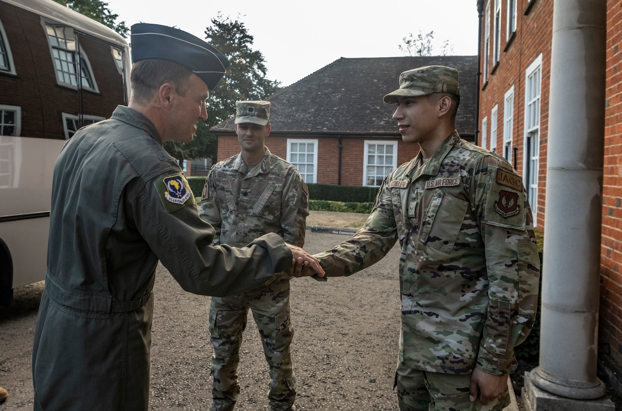 U.S. Air Force Lt. Gen. John D. Lamontagne awards a coin for superior performer to Airman 1st Class Desmond Archuleta