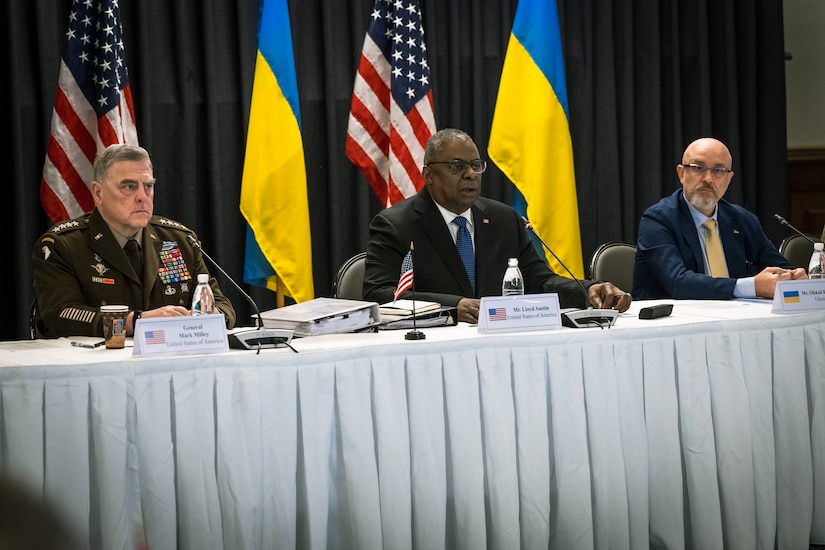 Three men sit behind a long table.