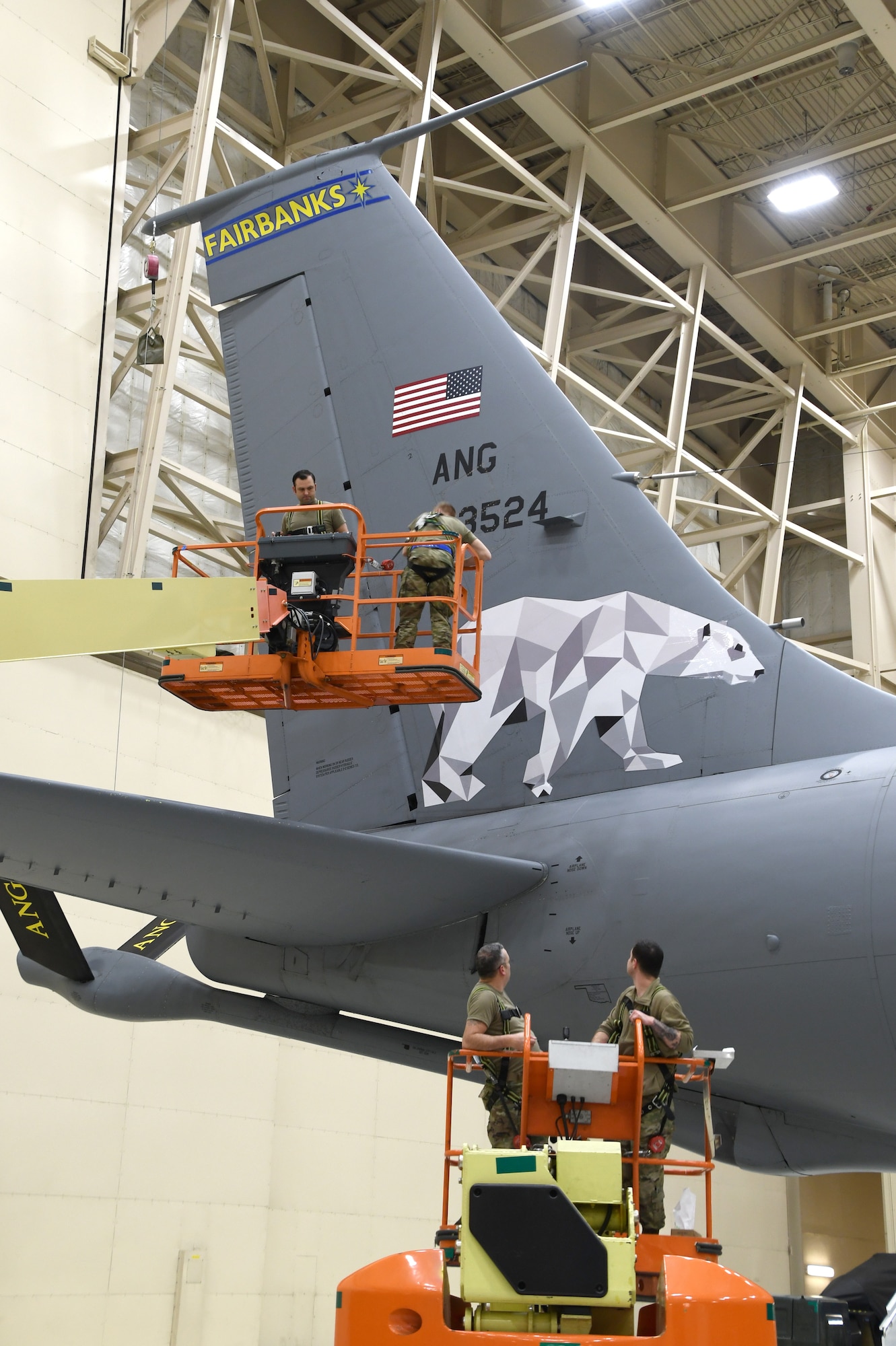 Tech. Sgt. Matthew Barker and Airman 1st Class Caleb Sawyer of the 168th Maintenance Group adds Fairbanks, Alaska to the wing's flagship KC-135 Stratotanker and installs the new Polar Bear design on the tail flash dedicated to Fairbanks, Alaska, Dec. 18, 2020. The Alaska Air National Guard's 168th Wing honors Fairbanks, Alaska, the city it calls home, with the dedication of the wing's flagship aircraft, Dec. 18. A flagship aircraft is a dedicated aircraft with the wing commander and the dedicated crew chiefs' names on it and is maintained to the highest standards. It is the jet that represents the wing. The dedicated crew chiefs for the flagship are Tech. Sgt. Robert Albaugh and Staff Sgt. Elliot St. Laurent. (U.S. Air National Guard photo by Senior Master Sgt. Julie Avey)