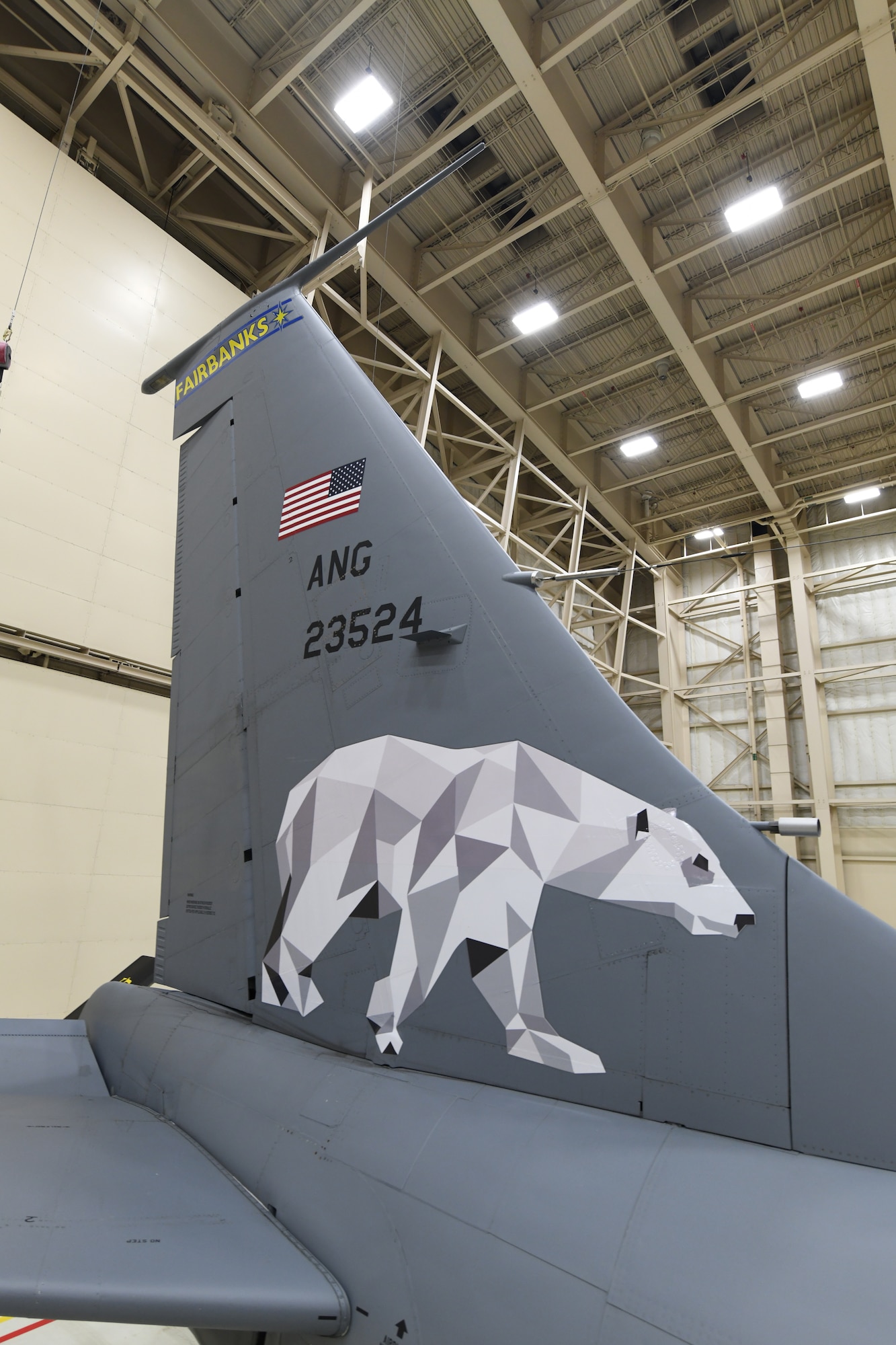 Tech. Sgt. Matthew Barker and Airman 1st Class Caleb Sawyer of the 168th Maintenance Group adds Fairbanks, Alaska to the wing's flagship KC-135 Stratotanker and installs the new Polar Bear design on the tail flash dedicated to Fairbanks, Alaska, Dec. 18, 2020. The Alaska Air National Guard's 168th Wing honors Fairbanks, Alaska, the city it calls home, with the dedication of the wing's flagship aircraft, Dec. 18. A flagship aircraft is a dedicated aircraft with the wing commander and the dedicated crew chiefs' names on it and is maintained to the highest standards. It is the jet that represents the wing. The dedicated crew chiefs for the flagship are Tech. Sgt. Robert Albaugh and Staff Sgt. Elliot St. Laurent. (U.S. Air National Guard photo by Senior Master Sgt. Julie Avey)
