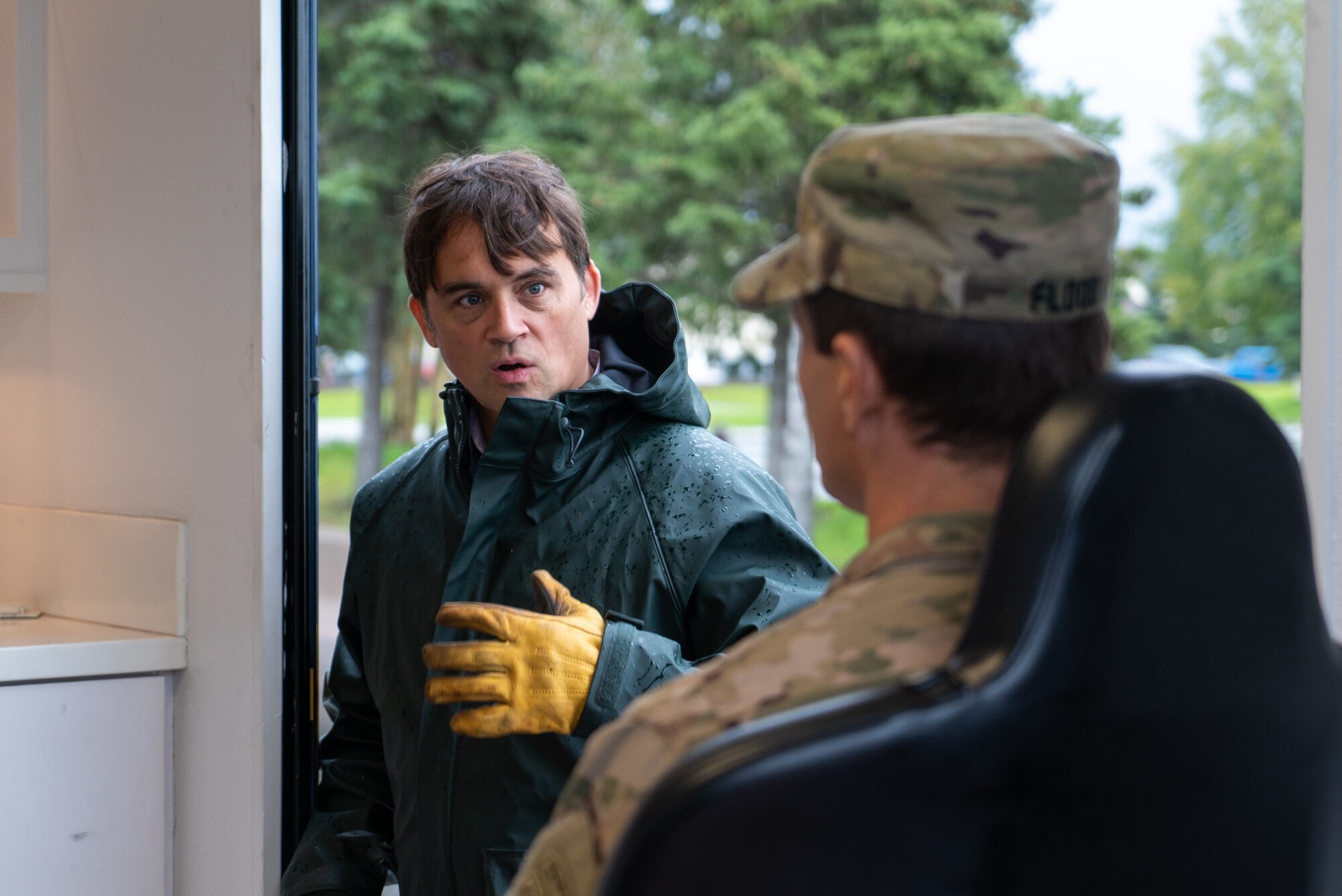 Jeremy Zidek explains to U.S. Army Maj. Eric Flood what to expect while experiencing Alaska's Earthquake Simulator.