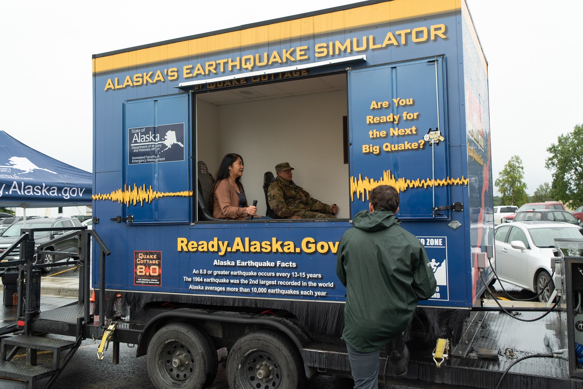 Ms. Roma Samson and U.S. Army Col. Don Makay get shaken back and forth while experiencing Alaska's Earthquake Simulator.