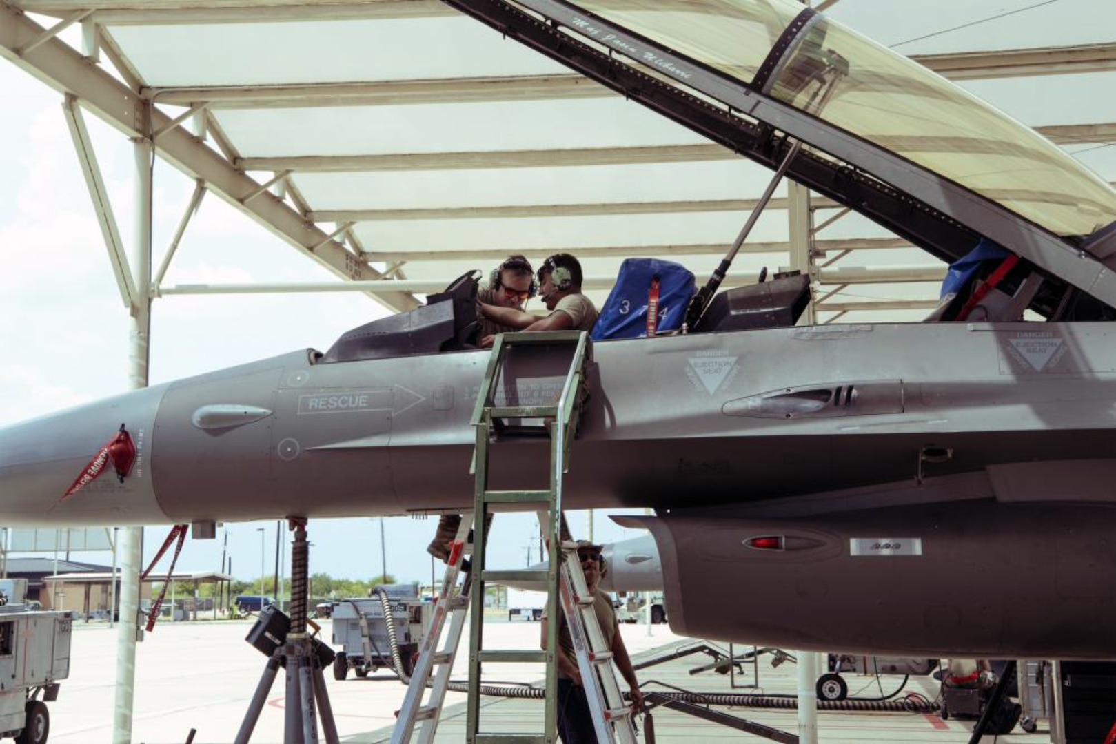 Crew chiefs from the 149th Maintenance Group perform a landing gear swings operations check on an F-16 Fighting Falcon