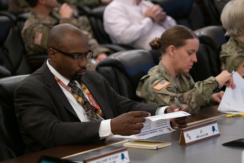 Christopher Walker reviews document contents while during a conference.