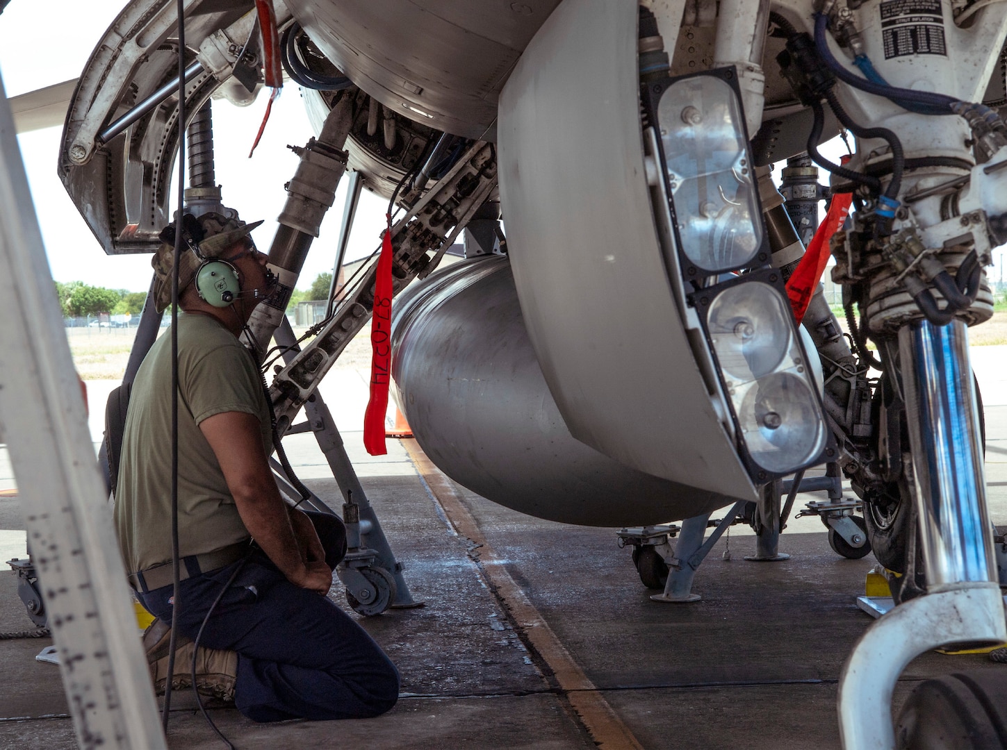 Crew chiefs from the 149th Maintenance Group perform a landing gear swings operations check on an F-16 Fighting Falcon