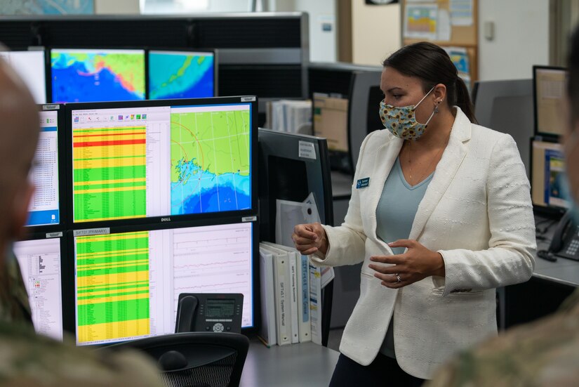 Dr. Summer Ohlendorf explains the types of collected data displayed on a screen in front of Alaskan Command staff