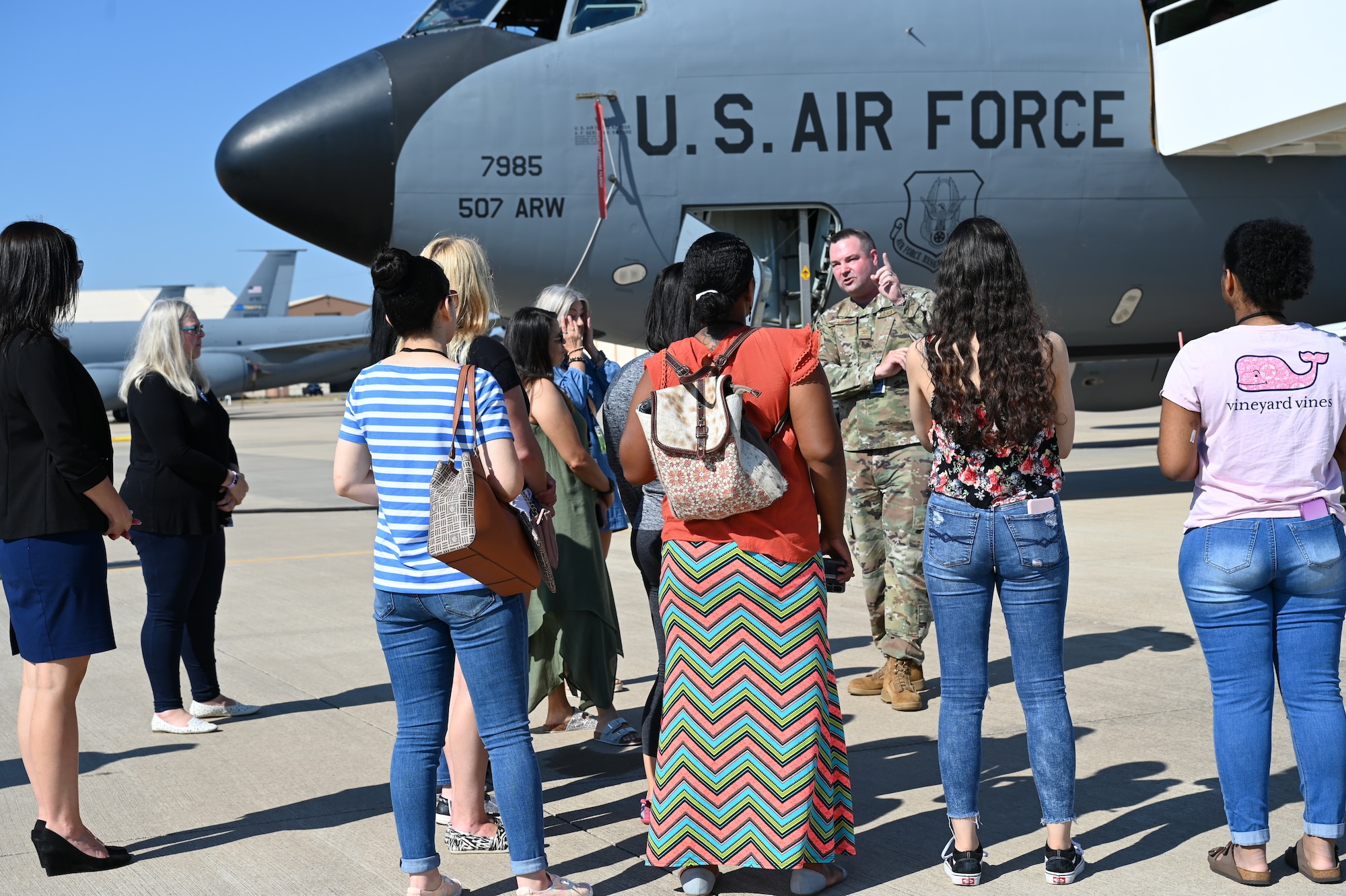 people standing in front of a plane