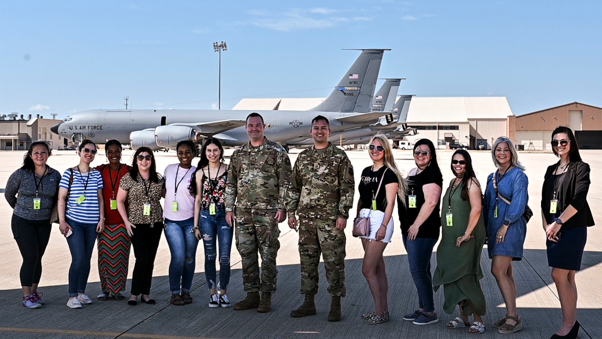 people stand in front of a plane