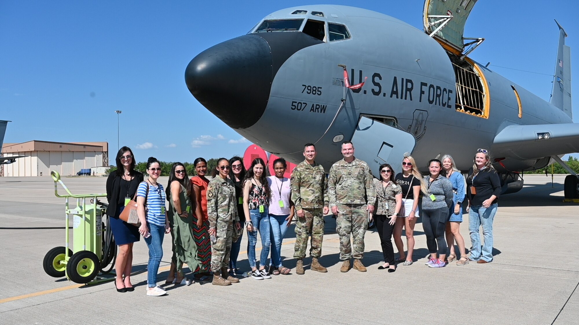 People standing in front of plane