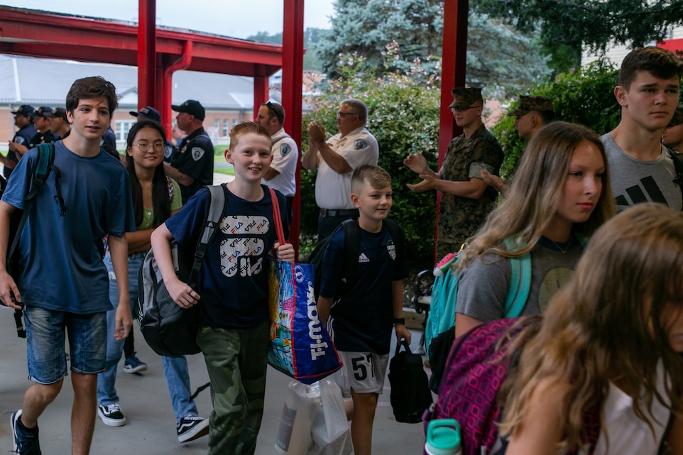 U.S. Marines greet students at Quantico Middle/High School during a back-to-school celebration at Marine Corps Base Quantico, Virginia, August 22, 2022. (U.S. Marine Corps photo by Pfc. Erick Reyes)