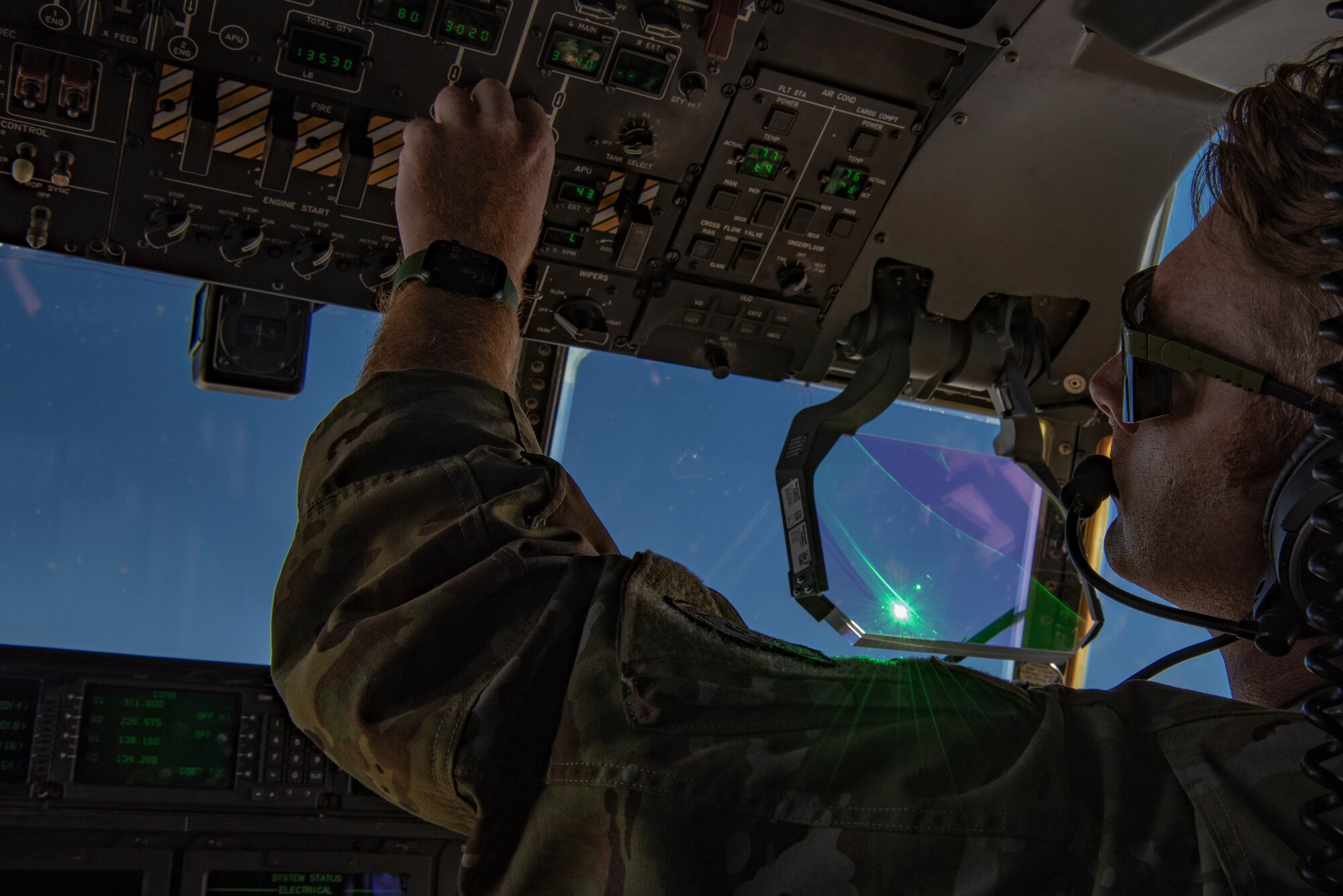 Capt. Sean Mishler, 40th Airlift Squadron pilot, adjusts the fuel tanks on a C-130J Super Hercules while flying over Texas, Aug. 29, 2022. During exercise Patriot Fury, Mishler and his aircrew loaded and offloaded heavy working equipment at Robert Gray Army Airfield, Fort Hood, Texas. (U.S. Air Force photo by Airman 1st Class Ryan Hayman)