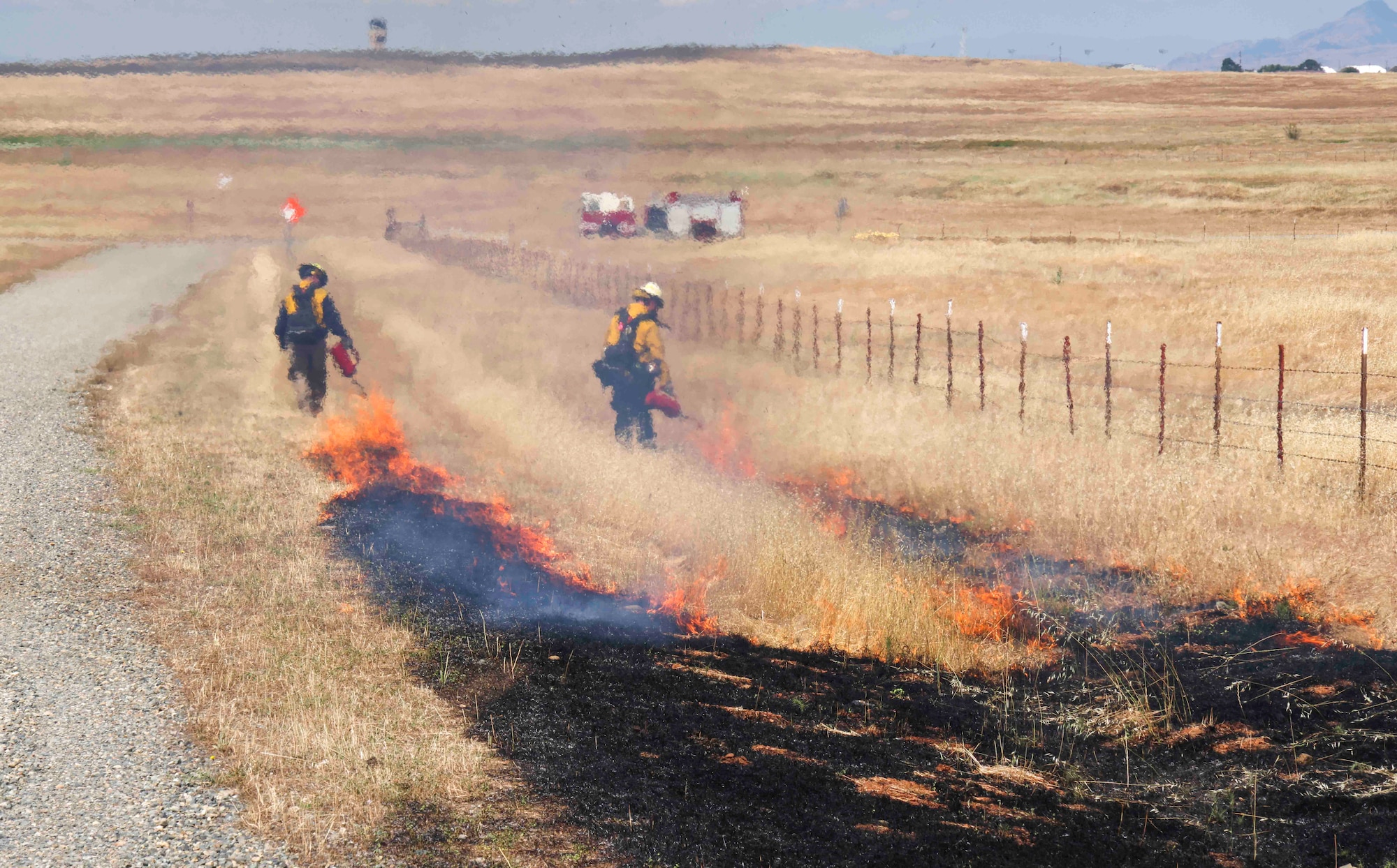 Crew members of the Air Force Civil Engineer Center Wildland Fire Support Module conduct a prescribed fire, also known as a controlled burn, on June 6th, 2022 at Beale Air Force Base, Calif.