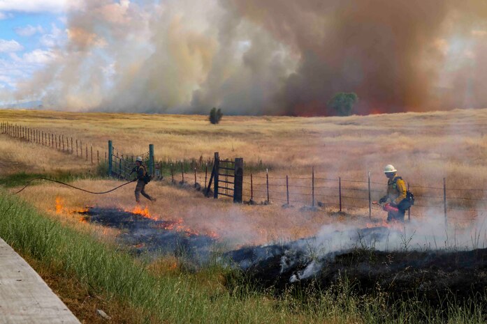 Crew members of the Air Force Civil Engineer Center Wildland Fire Support Module conduct a prescribed fire, also known as a controlled burn, on June 6th, 2022 at Beale Air Force Base, Calif.