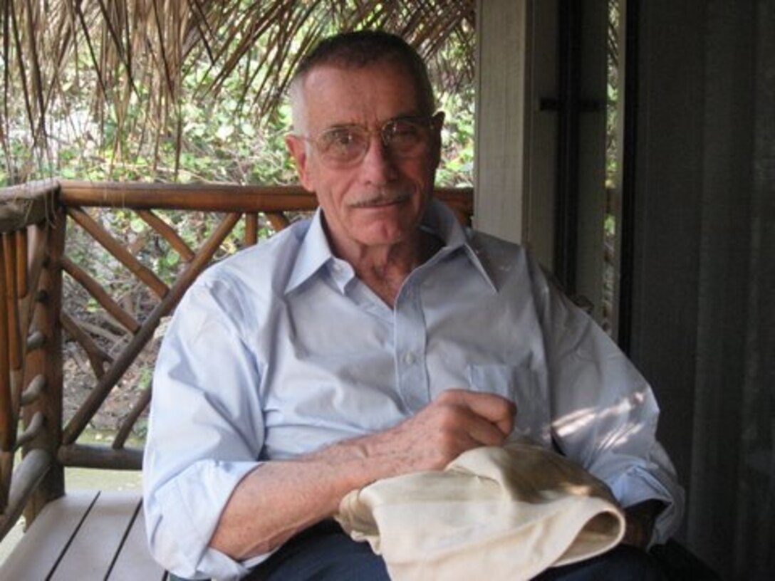A man sits on a patio.