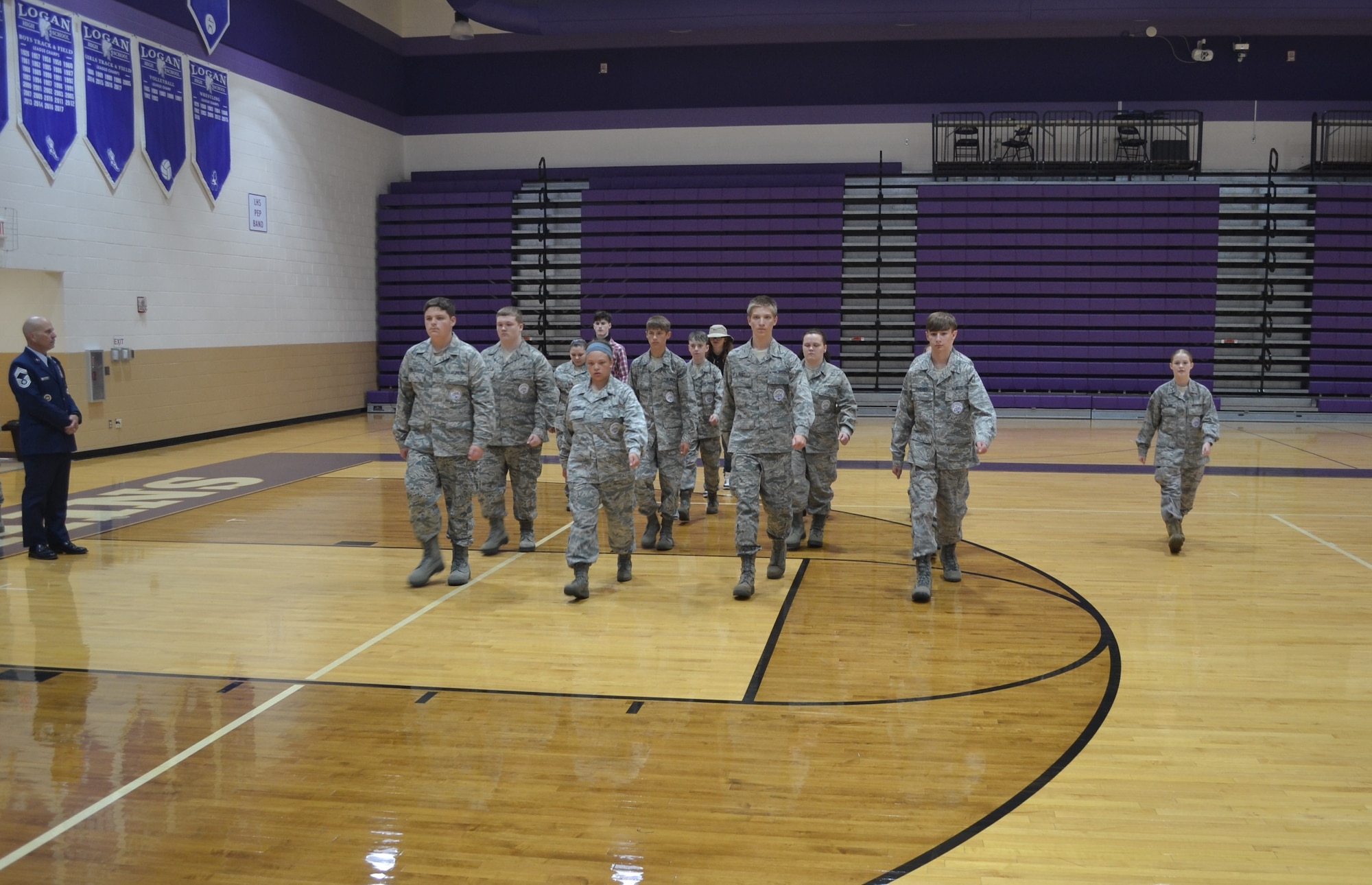 Retired Chief Master Sgt. David Dillon, an Air Force Junior ROTC Aerospace Science Instructor, observes as Cadet Emily Taulbee, right, practices marching a flight of new cadets at Logan High School in Logan, Ohio, Aug. 29, 2022.  Logan High School received approval to start an Air Force Junior ROTC program last year, and the program started its first full academic year in August of 2022.