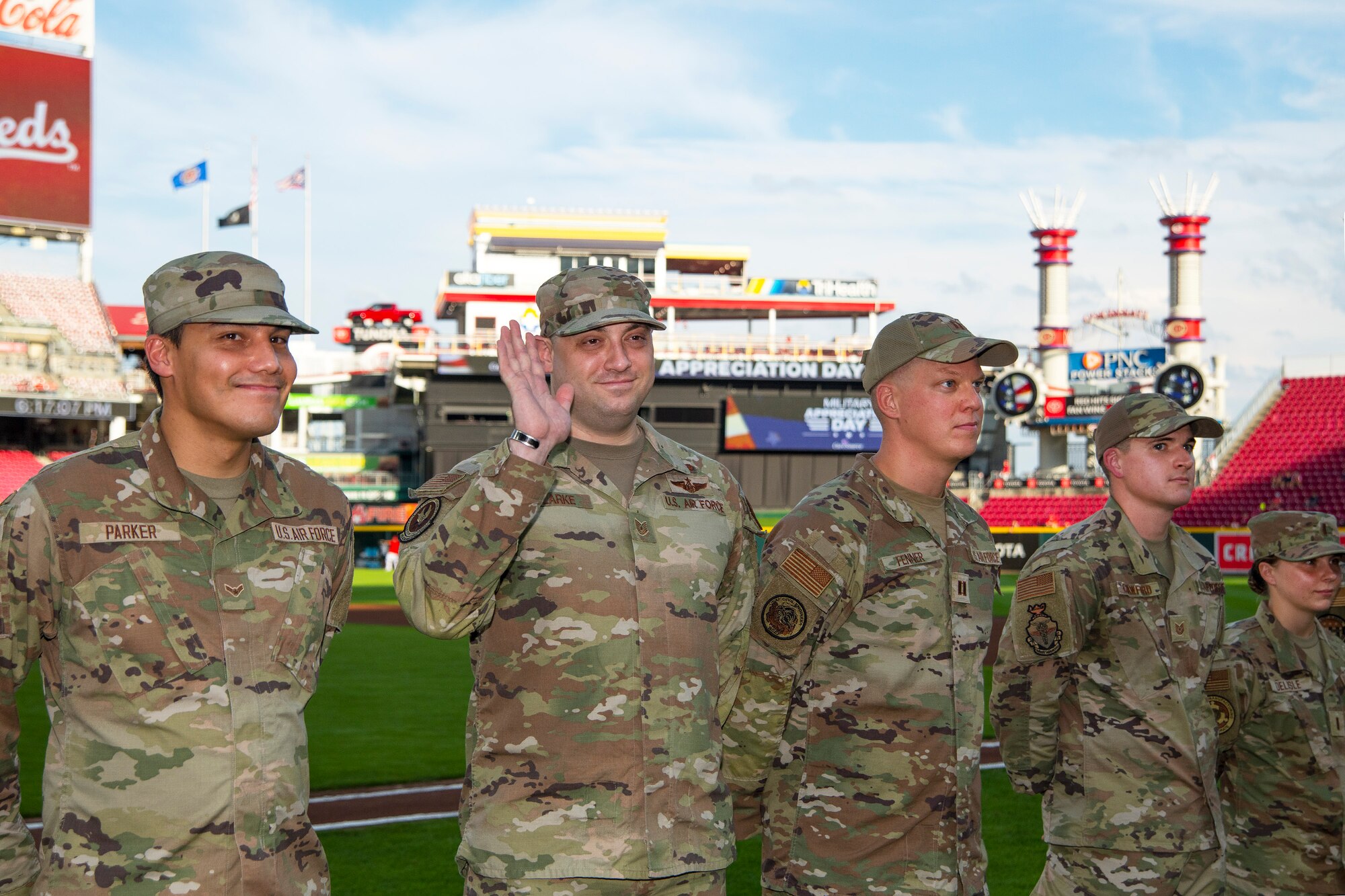 Tech. Sgt. Devin Clarke, Air Force Materiel Command, waves as he is introduced among Wright-Patterson Air Force Base’s Outstanding Airmen during pregame activities Sept. 2, 2022, at Great American Ball Park in Cincinnati. The event was part of the Reds’ annual Military Appreciation Night. (U.S. Air Force photo by R.J. Oriez)