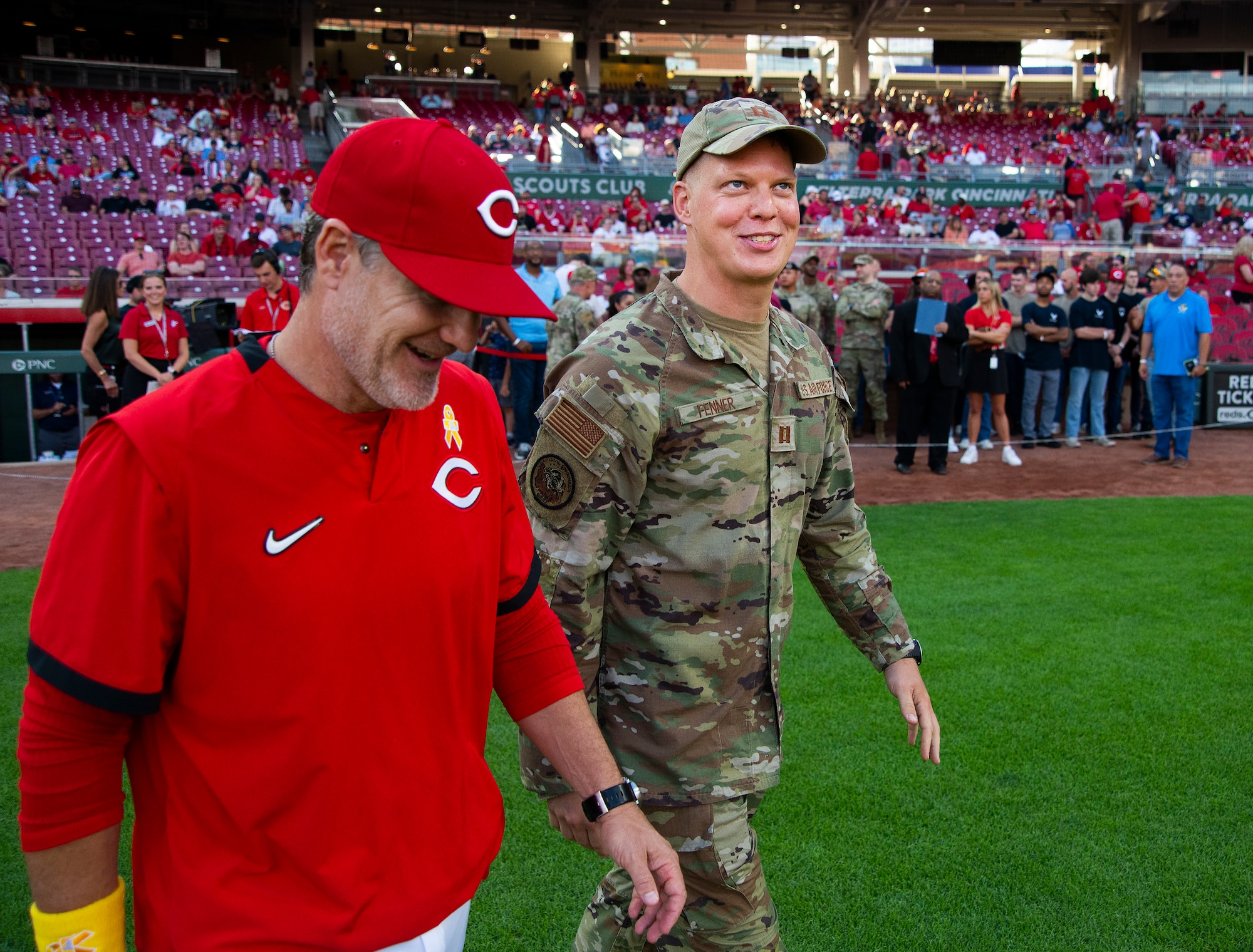 Capt. Andrew Fenner, Air Force Institute of Technology, accompanies Cincinnati Reds manager David Bell out to home plate to exchange lineup cards before the game Sept. 2, 2022, against the Colorado Rockies at Great American Ball Park in Cincinnati. Fenner was named honorary captain as part of the Reds’ annual Military Appreciation Night. (U.S. Air Force photo by R.J. Oriez)