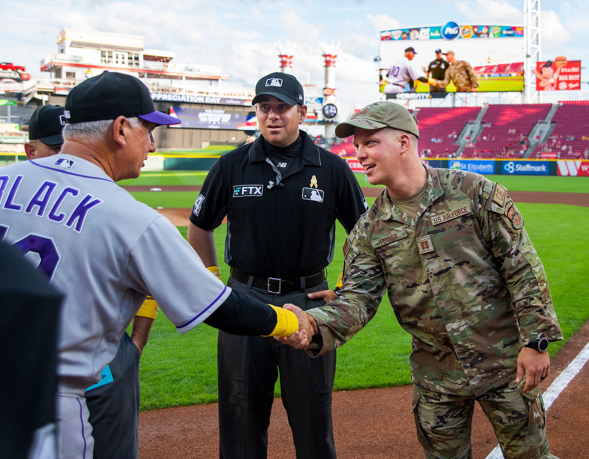 Capt. Andrew Fenner, Air Force Institute of Technology, shakes hands with Colorado Rockies manager Bud Black before the club’s game against the Reds on Sept. 2, 2022, at Great American Ball Park in Cincinnati. Fenner was named honorary captain as part of the Reds’ annual Military Appreciation Night. (U.S. Air Force photo by R.J. Oriez)