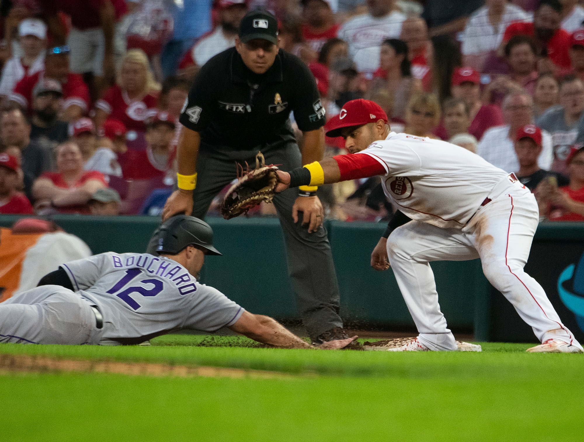 The Colorado Rockies’ Sean Bouchard dives back to avoid a pickoff attempt as Reds first baseman Donovan Solano awaits the throw Sept. 2, 2022. Bouchard made it safely back to the bag on the night the hometown Reds honored Wright-Patterson Air Force Base Airmen with their annual Military Appreciation Night. (U.S. Air Force photo by R.J. Oriez)