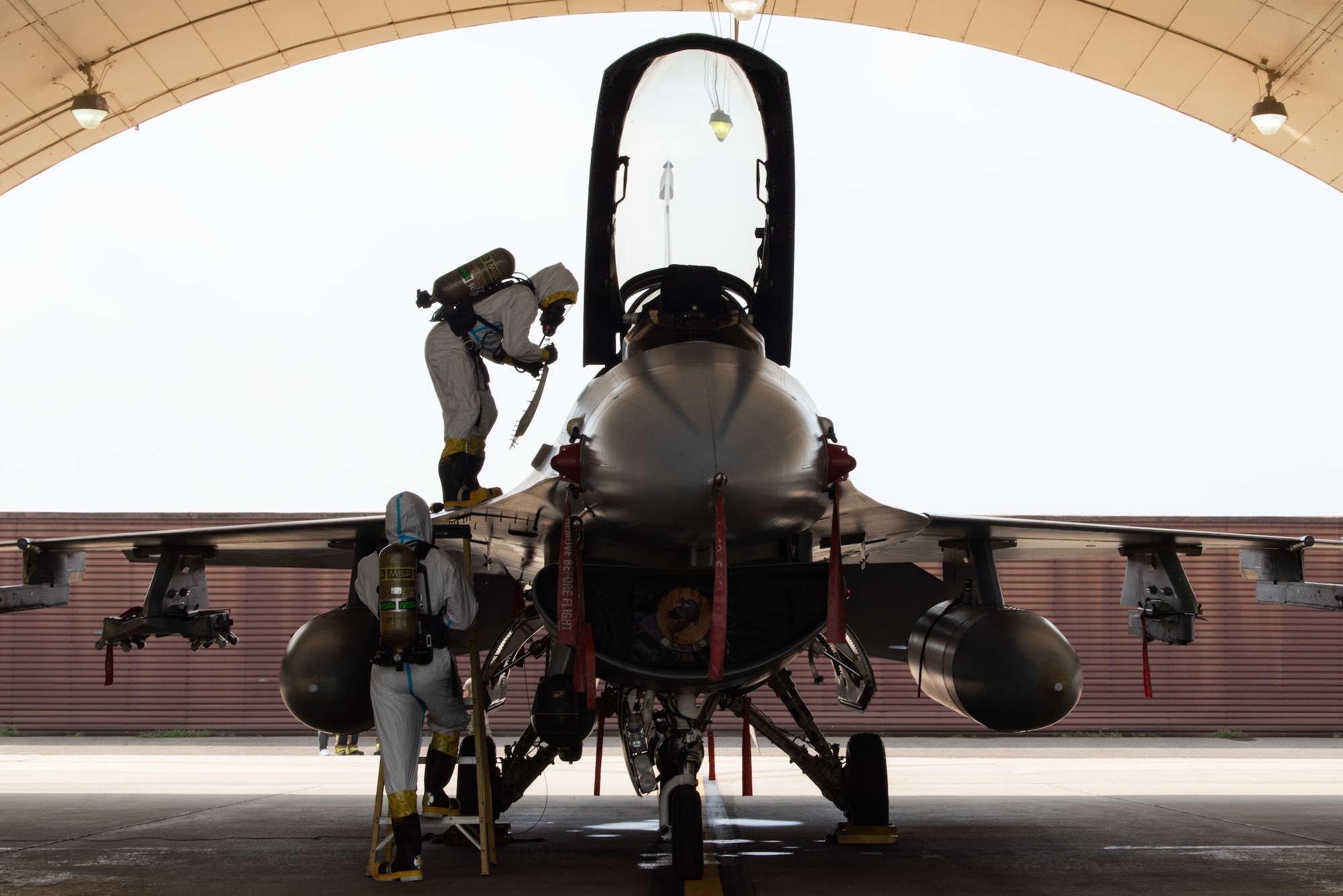 Senior Airman Christian Byrd, 51st Maintenance Squadron aircraft fuel systems journeyman, and Airman Basic Marceleno Misael, 51st MXS aircraft fuel systems apprentice, begin response procedures for a hydrazine fuel spill during a training at Osan Air Base, Republic of Korea, Aug. 26, 2022.