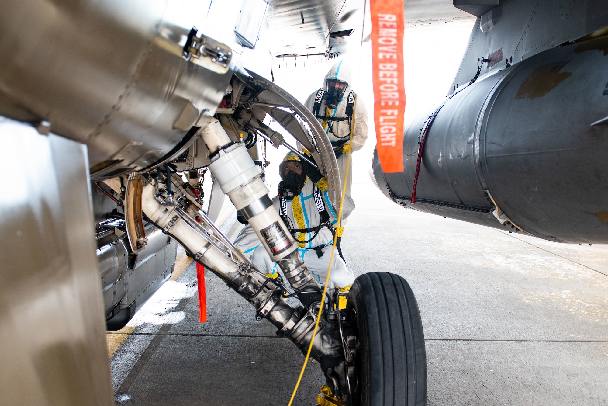 Senior Airman Christian Byrd, 51st Maintenance Squadron aircraft fuel systems journeyman, and Airman Basic Marceleno Misael, 51st MXS aircraft fuel systems apprentice, inspect panels on an F-16 Fighting Falcon during a hydrazine response training at Osan Air Base, Republic of Korea, Aug. 26, 2022.