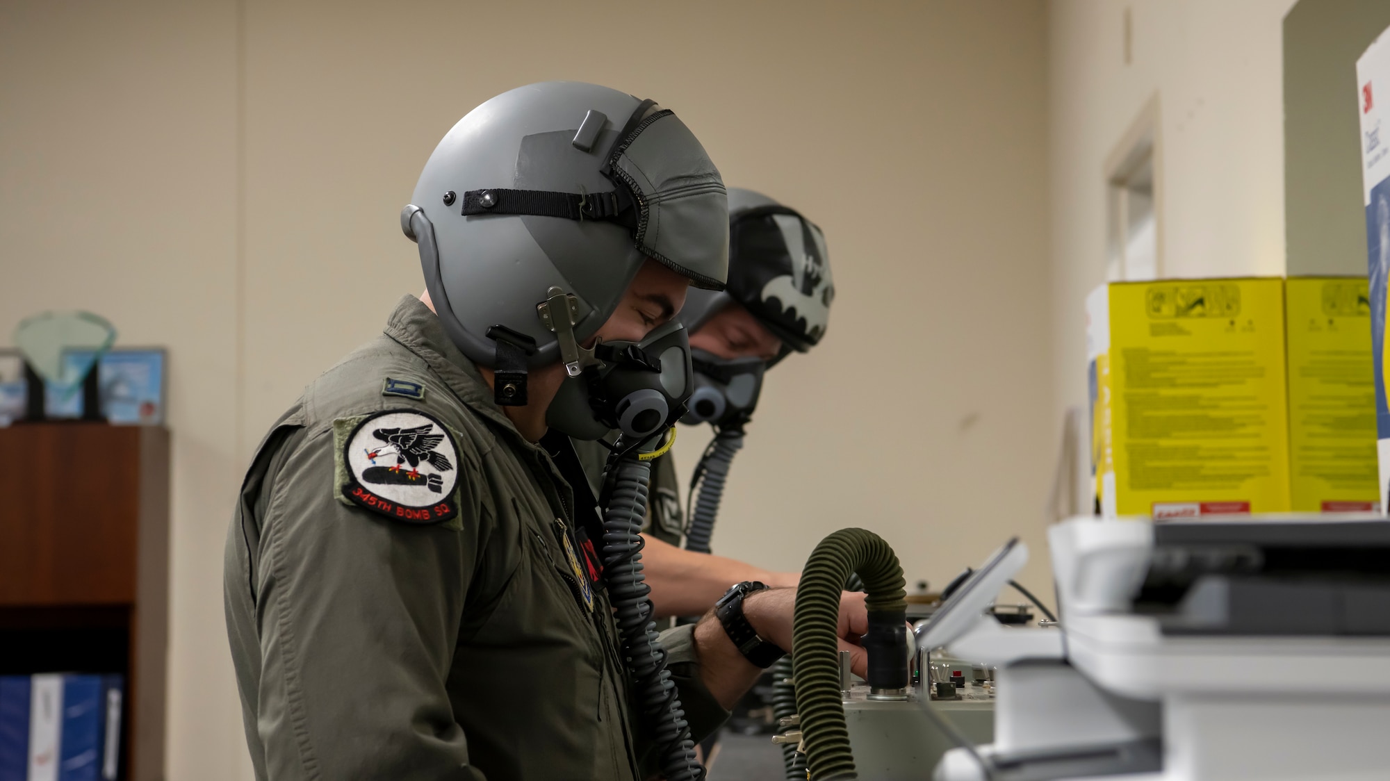 Capt. Ryan Woods, 345th Bomb Squadron weapons systems officer, checks his mask before flight at Dyess Air Force Base, Texas Sept. 7th, 2022. Crews supported a Bomber Task Force mission to U.S. Southern Command. Within the mission, they integrated with partnered nations, such as Ecuador and Panama. (U.S. Air Force photo by Senior Airman Mercedes Porter)