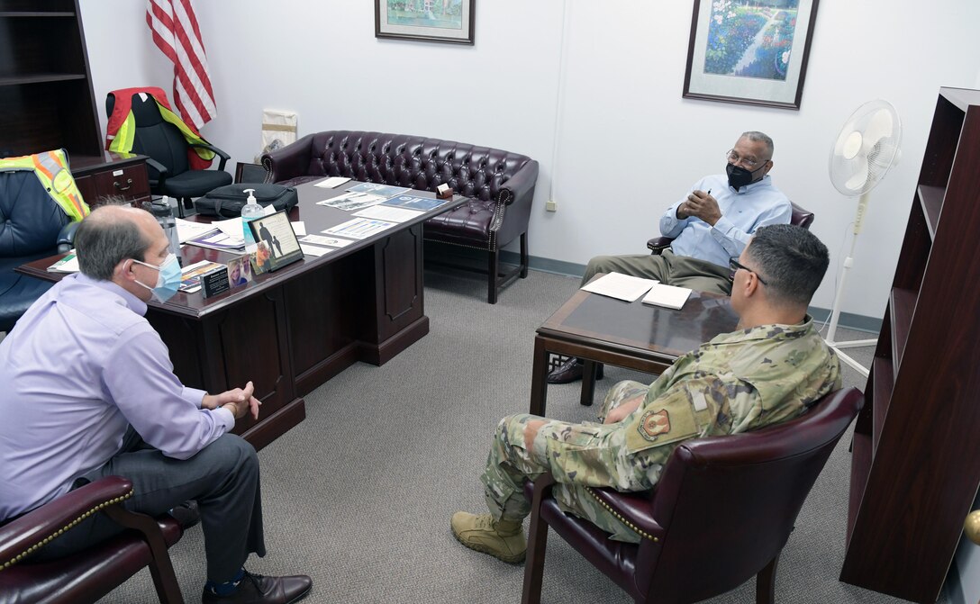 Three men sitting in chairs