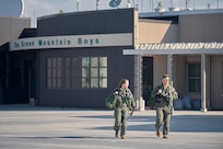 A photo of 1st Lt. Kelsey Flannery, an F-35A Lightning II pilot, and Capt. Jake Dubie, an instructor pilot, both assigned to the 134th Fighter Squadron of the Vermont Air National Guard's 158th Fighter Wing, head to their jets for a training mission from South Burlington Air National Guard Base, Vermont, Sept. 7, 2022. Flannery, who is the Air National Guard's first female F-35 pilot, made her first flight with the 158th after returning from three years of flight training. (U.S. Air National Guard photo by Master Sgt. Ryan Campbell)