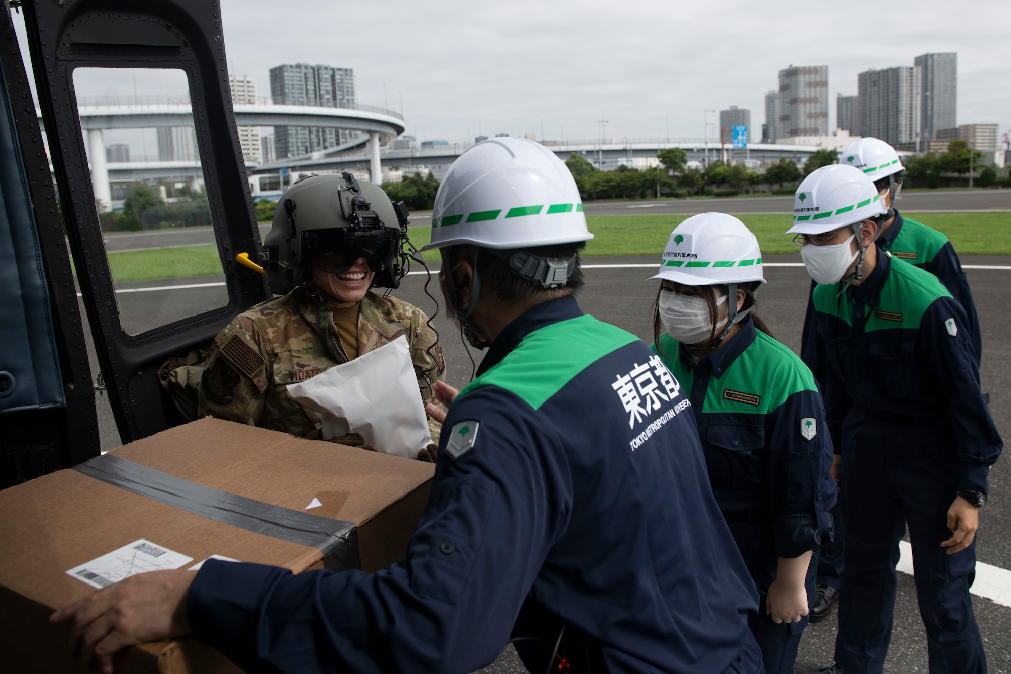 Tech. Sgt. Alexandra Vidato, 459th Airlift Squadron instructor flight engineer, assists Tokyo Metropolitan Government personal with a box of simulated humanitarian aid during a disaster preparedness and response drill at Tokyo Rinkai Disaster Prevention Park, Japan, Sept. 3, 2022. To further build upon the partnership with the TMG, the 459th is planning to participate in more disaster relief training in the future. (U.S. Air Force photo by Tech. Sgt. Joshua Edwards)