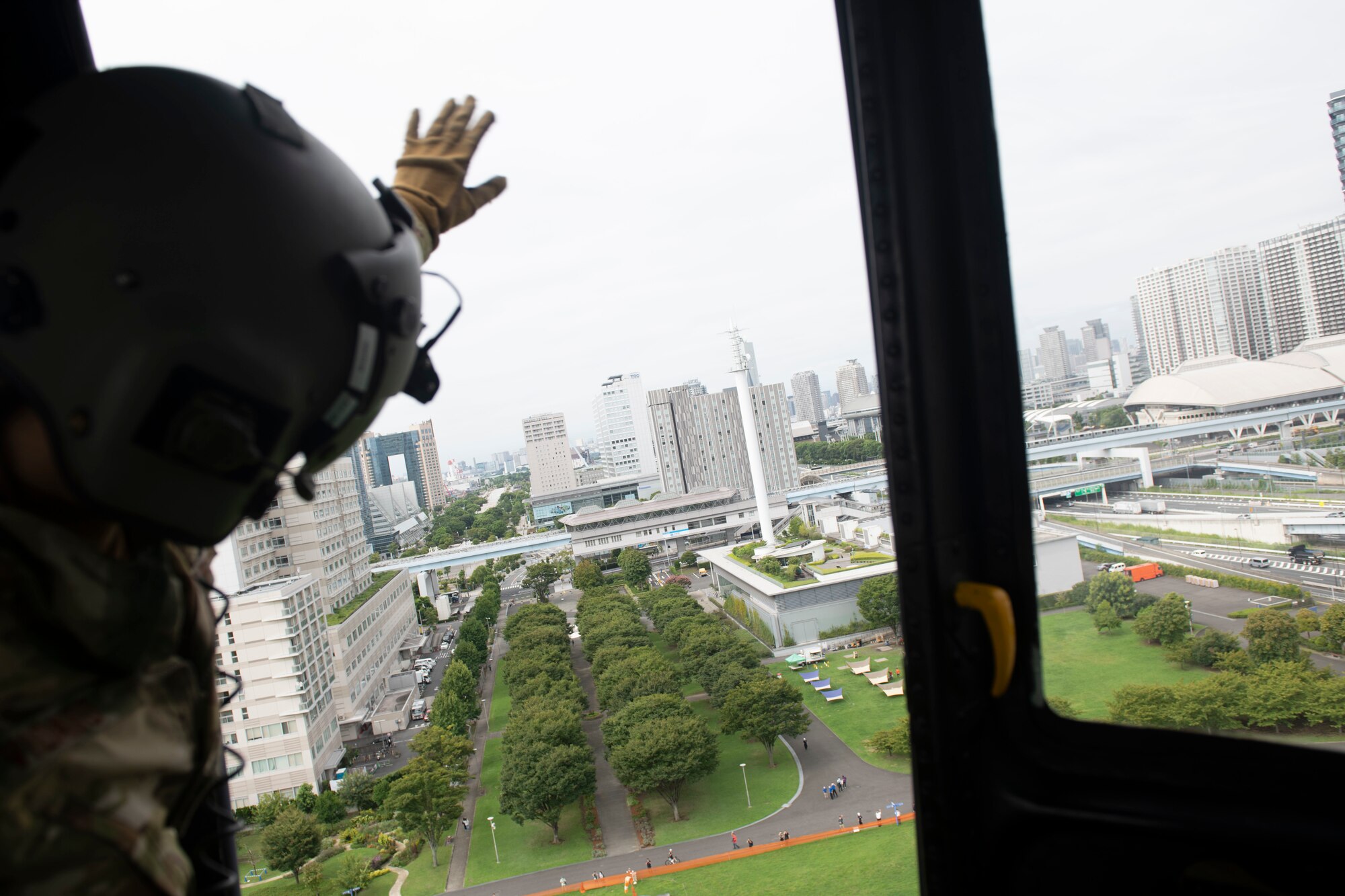 Tech. Sgt. Alexandra Vidato, 459th Airlift Squadron instructor flight engineer, waves goodbye after delivering simulated humanitarian aid during a Tokyo Metropolitan Government hosted disaster preparedness and response drill at Tokyo Rinkai Disaster Prevention Park, Japan, Sept. 3, 2022. The U.S. Army and Navy, as well as the Japan Air Self-Defense Force, participated alongside the 459th AS to ensure mission readiness in the event of a real-world disaster. (U.S. Air Force photo by Tech. Sgt. Joshua Edwards)