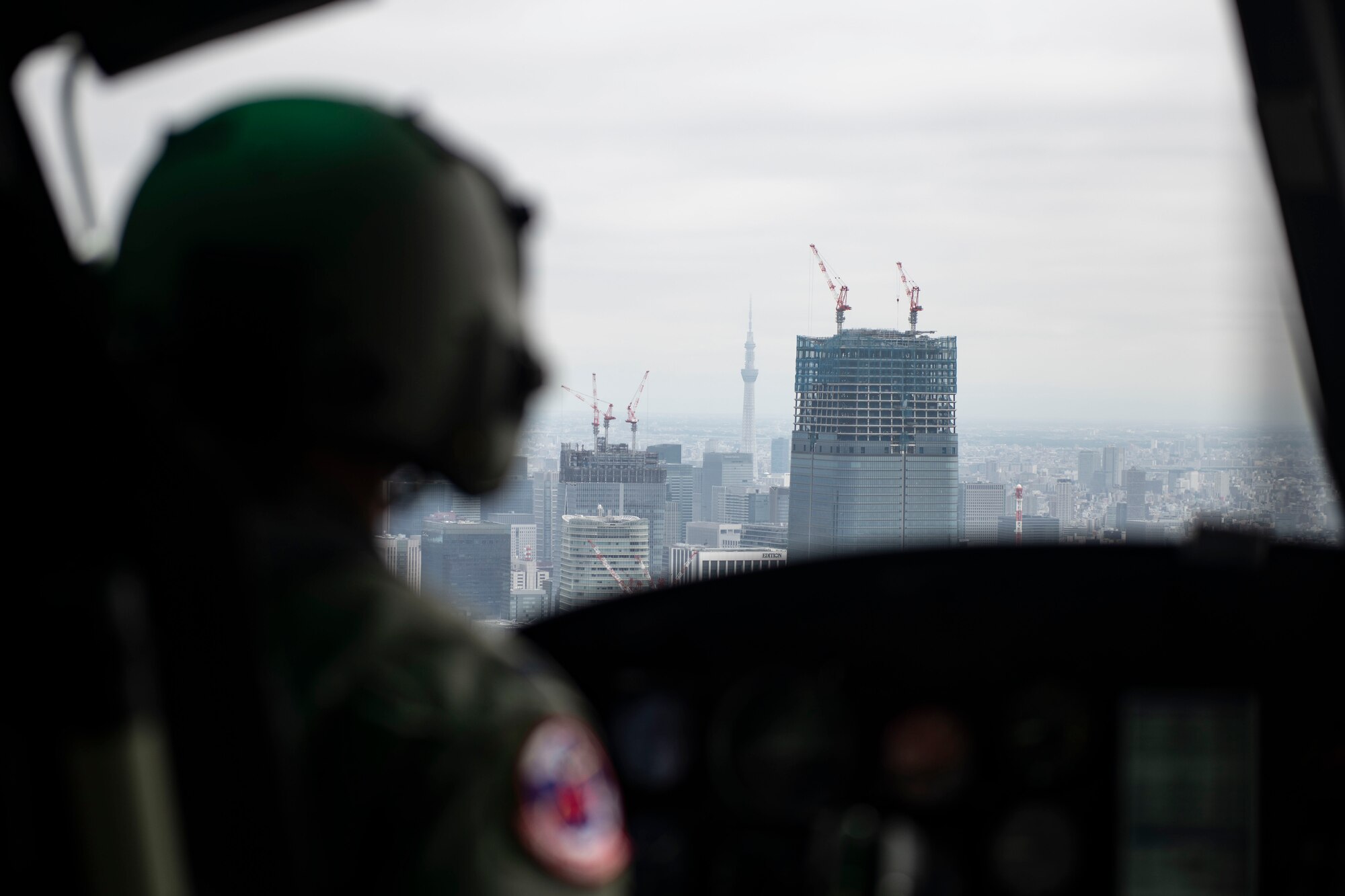 Capt. Matthew Helm, 459th Airlift Squadron UH-1N Iroquois pilot, navigates around Tokyo for a Tokyo Metropolitan Government hosted disaster preparedness and response drill at Tokyo Rinkai Disaster Prevention Park, Japan, Sept. 3, 2022. The U.S. Army and Navy, as well as the Japan Air Self-Defense Force, participated alongside the 459th AS to ensure mission readiness in the event of a real-world disaster. (U.S. Air Force photo by Tech. Sgt. Joshua Edwards)