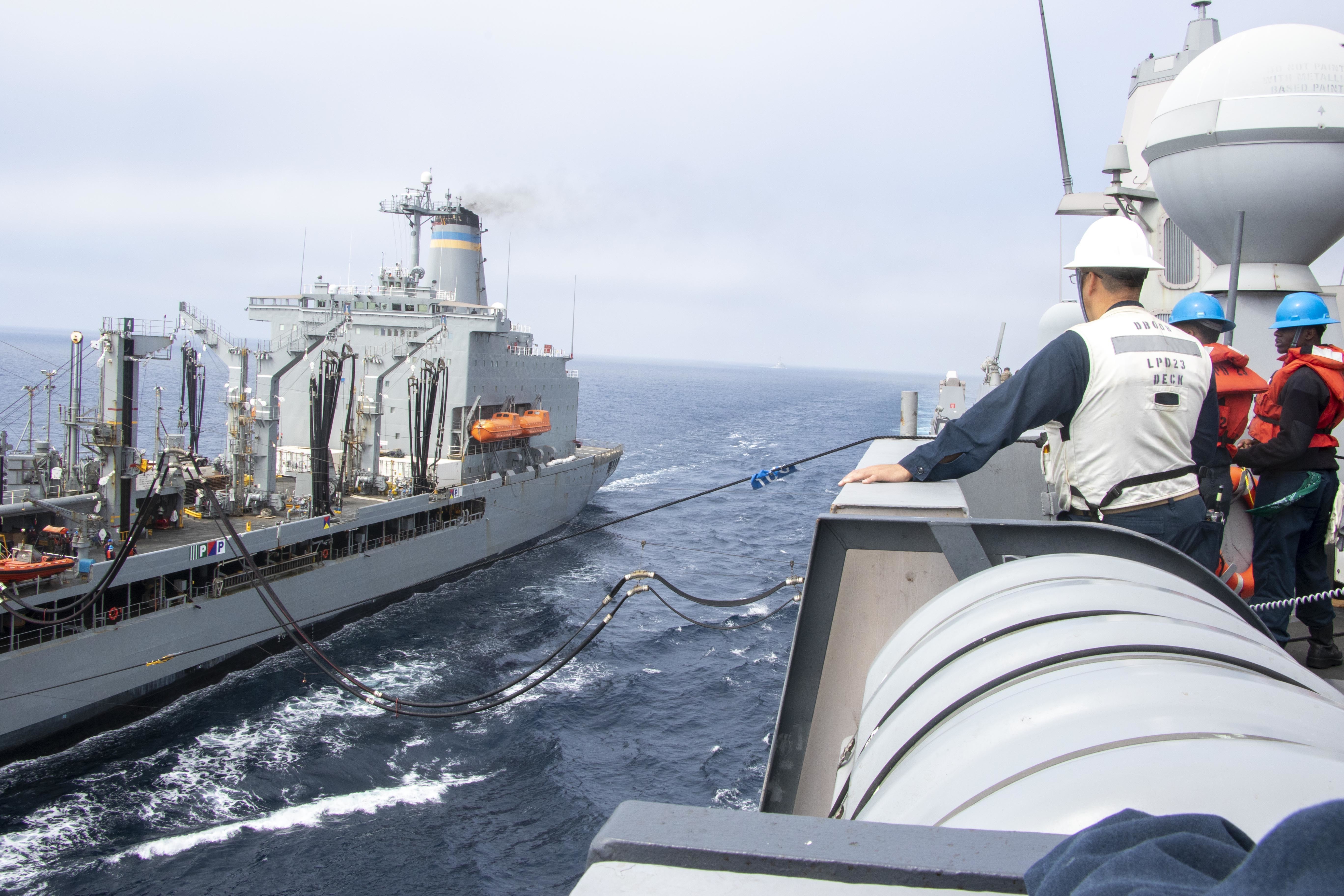 USNS Henry J. Kaiser (T-AKE 187) prepares to break away from the amphibious transport dock ship USS Anchorage (LPD 23) after a replenishment-at-sea.
