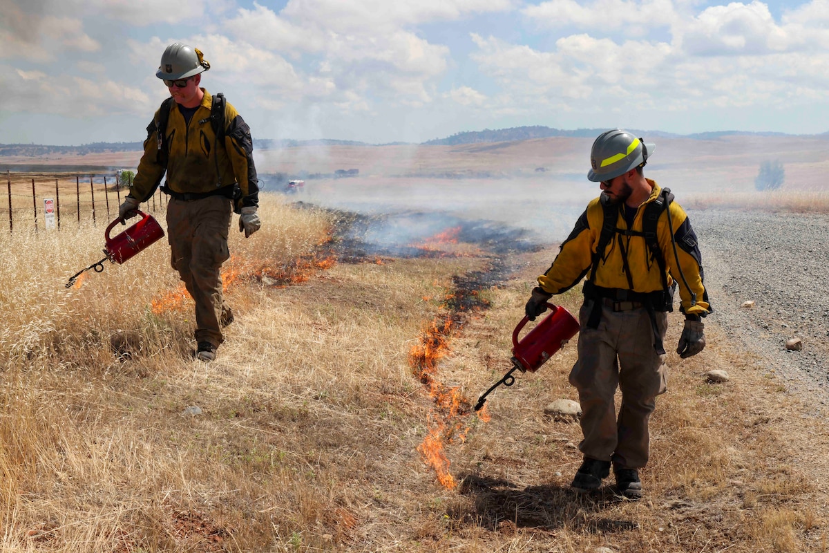 Crew members of the Air Force Civil Engineer Center Wildland Fire Support Module conduct a prescribed fire, also known as a controlled burn, on June 6th, 2022 at Beale Air Force Base, Calif.