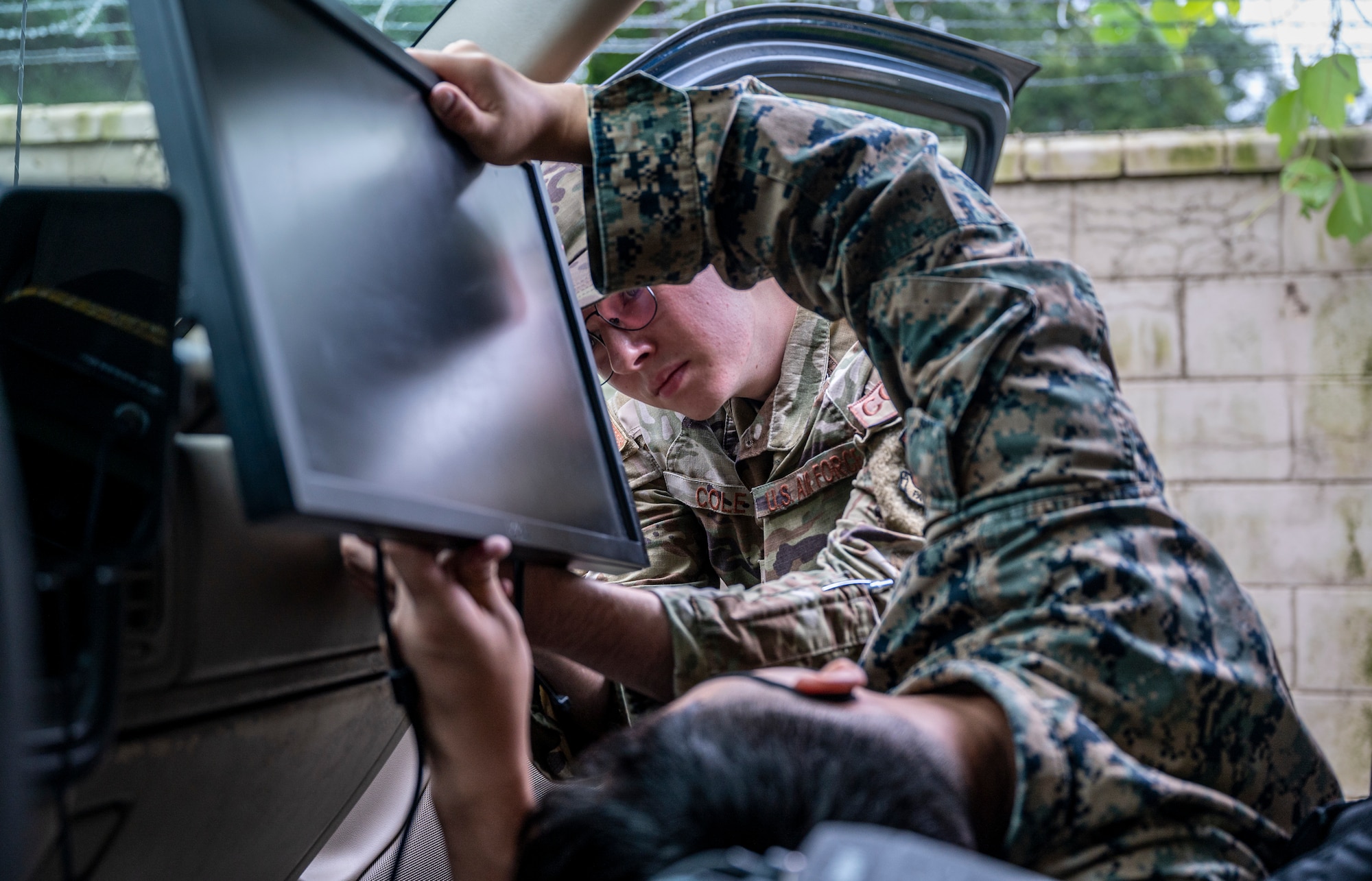U.S Marine Corps. Sgt. Jaden Mensalvas, intelligence analyst, and Senior Airman Jonas Cole, 621st Air Control Squadron cyber systems operations technician, mount a computer screen in a mobile tactical command and control (C2) vehicle at Yongin Army Base, Republic of Korea, Aug. 31, 2022.