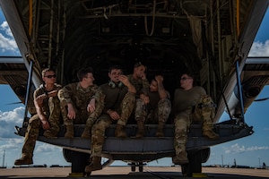 A group of Dyess Air Force Base Airmen await the load of a C-130J Super Hercules at Naval Air Station Fort Worth, Texas, Aug. 28, 2022. During exercise Patriot Fury, the 317th Airlift Wing integrated with the 301st Fighter Wing, special forces and the 621st Crisis Response Team, Joint Base McGuire-Dix-Lakehurst, New Jersey. (U.S. Air Force photo by Airman 1st Class Ryan Hayman)