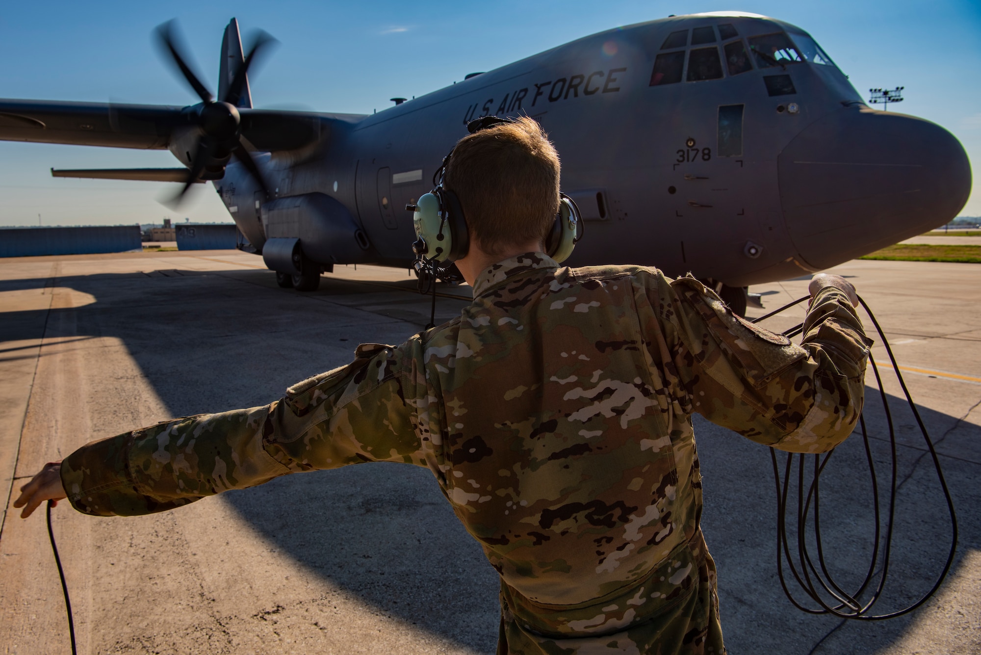 Airman 1st Class Ryker Kiselewski, 39th Airlift Squadron loadmaster, clears the propellers during an engine start of a C-130J Super Hercules during exercise Patriot Fury at Naval Air Station Fort Worth, Texas, Aug. 27, 2022. Clearing the propellers during engine start is an essential component to ensure the safety of personnel. (U.S. Air Force photo by Airman 1st Class Ryan Hayman)