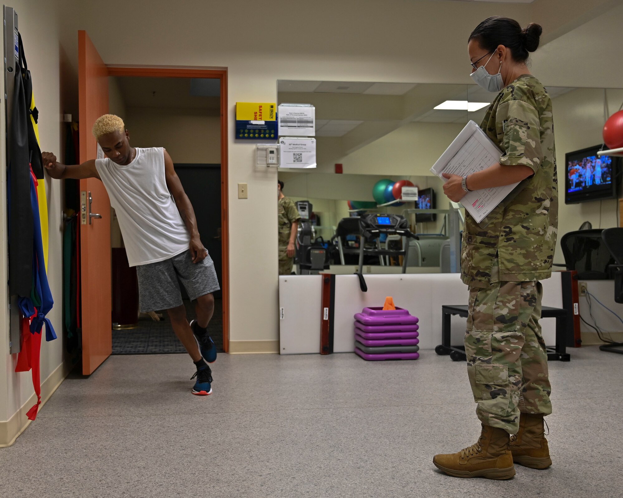 U.S. Air Force Staff Sgt. Monica Rivera, 36th Medical Group Physical Therapy Clinic noncommissioned officer in charge, watches a patient perform eccentric heel raises at the PT Clinic on Andersen Air Force Base, Guam, Sept. 7, 2022. This exercise helps strengthen calf muscles and reduces tension on the achilles tendon. (U.S. Air Force photo by Airman 1st Class Lauren Clevenger)