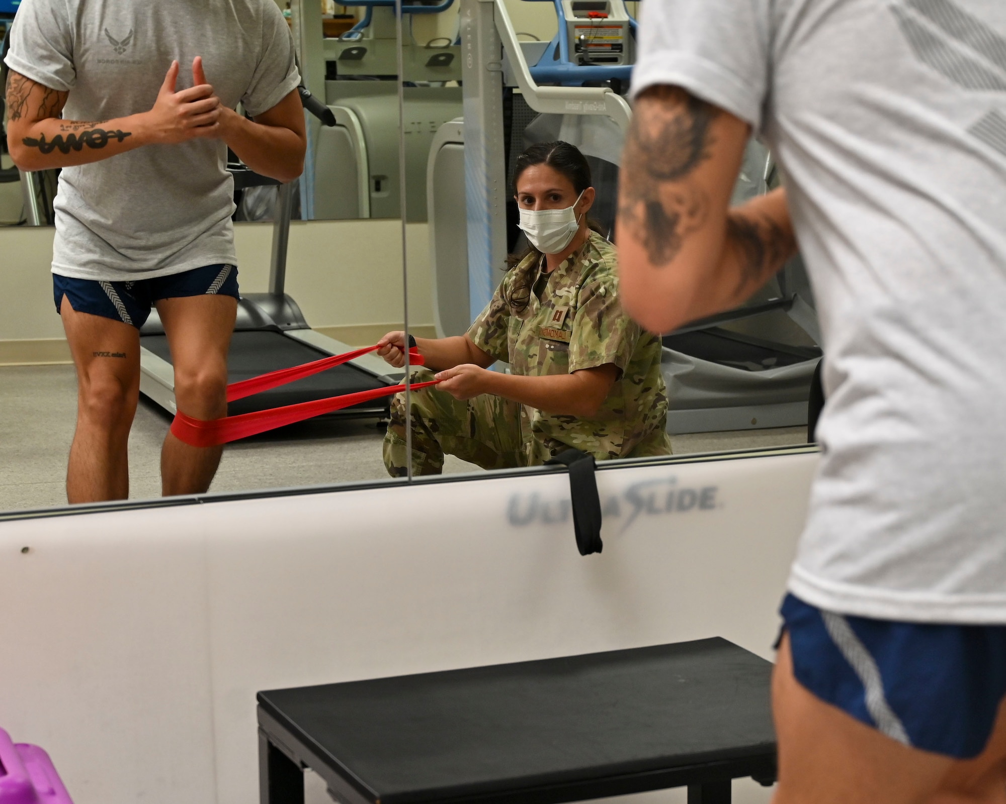 U.S. Air Force Capt. Meredith LaKomski, 36th Medical Group Physical Therapy Clinic element chief, holds a TheraBand during a lateral step down exercise with a patient at the PT Clinic on Andersen Air Force Base, Guam, Sept. 7, 2022. Physical therapists are trained on the intricate movements of the body and have the knowledge to teach others preventative resources to stop injuries from occurring. (U.S. Air Force photo by Airman 1st Class Lauren Clevenger)