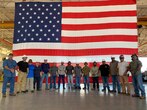 US Flag Backdrop Gets Constructed for SGM Ceremony