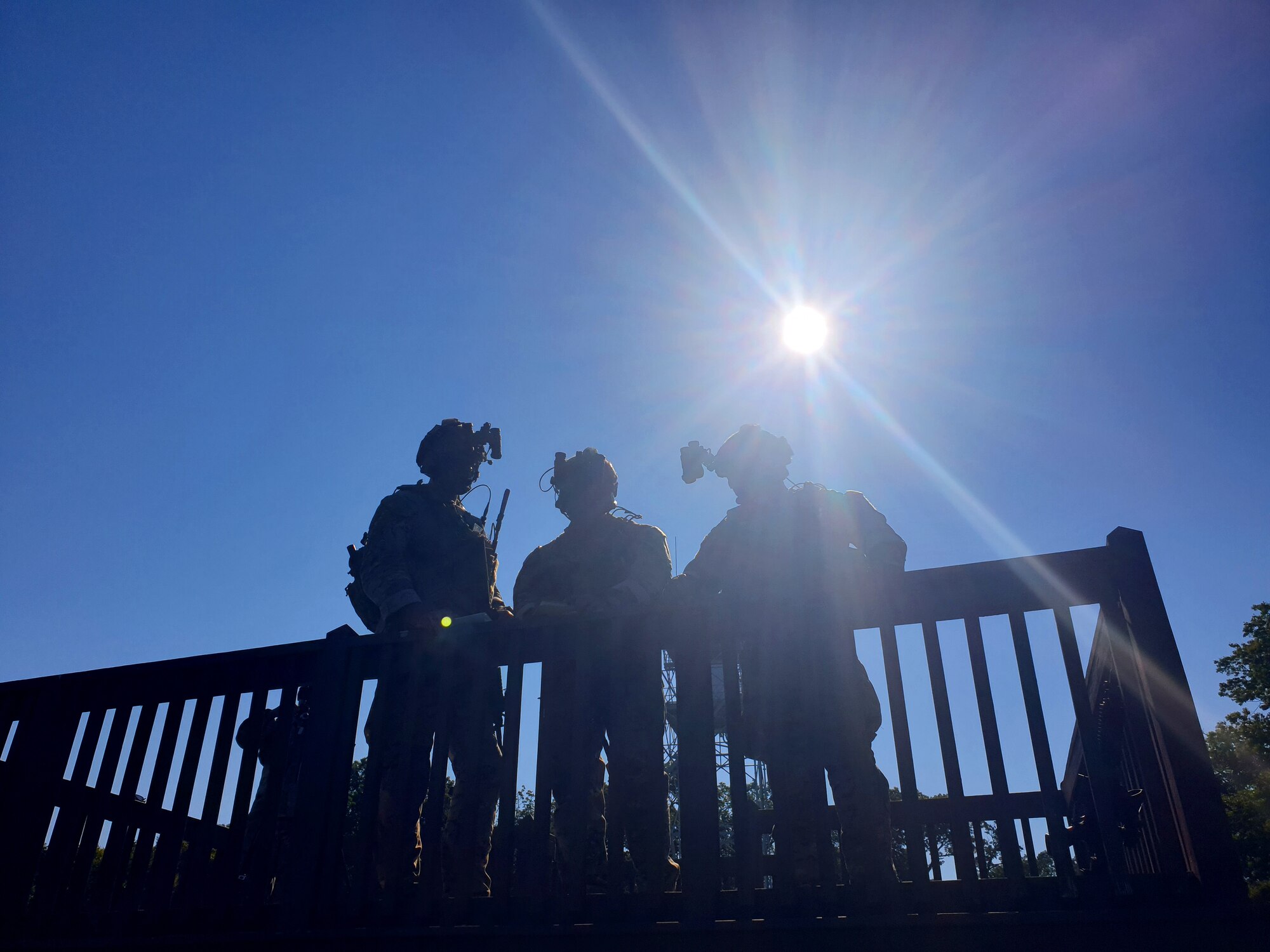 This is a silhouette of four troops on an elevated platform.