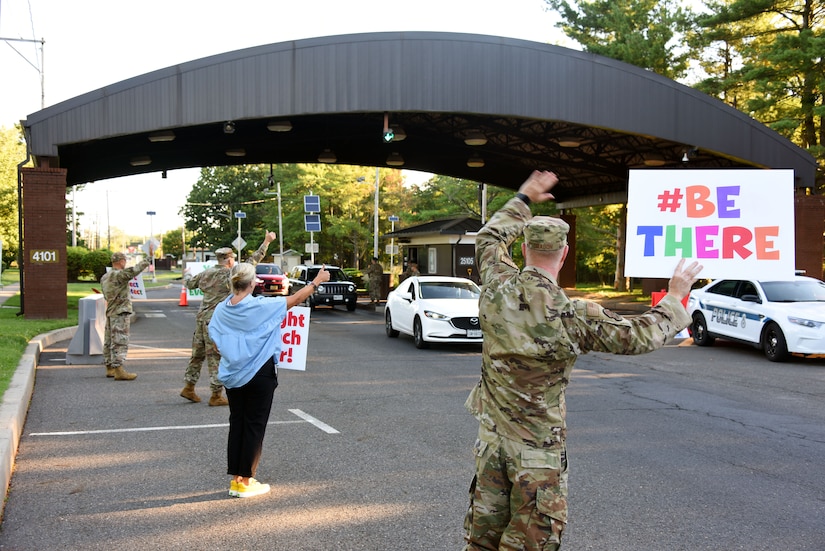 Members of the Suicide Prevention Awareness program greet drivers into JB MDL.