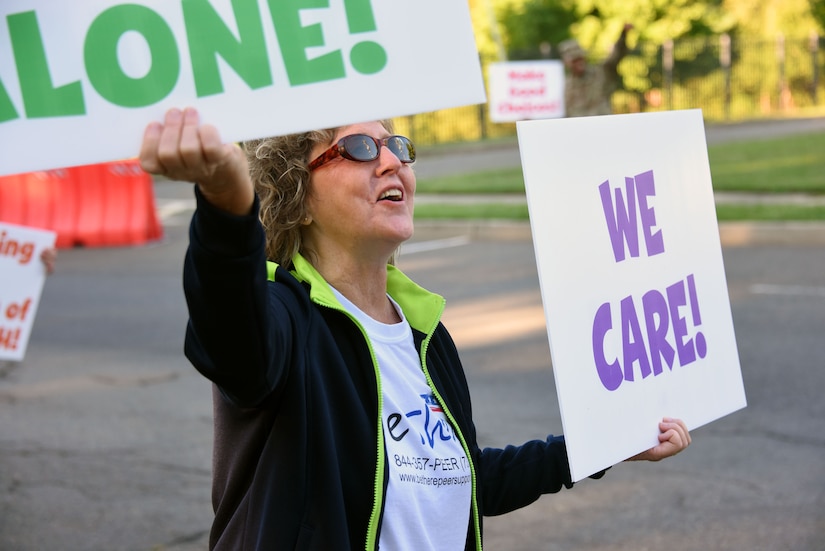 Suicide Prevention Awareness Program manager greets drivers on JB MDL