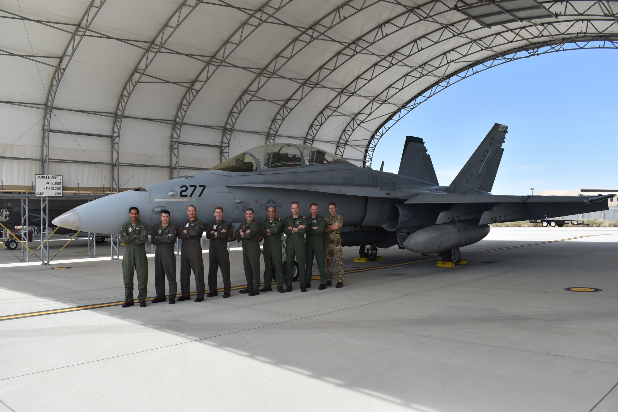 Pilots from Marine Fighter Attack Training Squadron (VMFAT-101) stand beside an F/A-18D aircraft after a U.S. Operational Test Team mission. The F/A-18D brings advanced, "4th plus" generation capability to UOTT test and training missions."