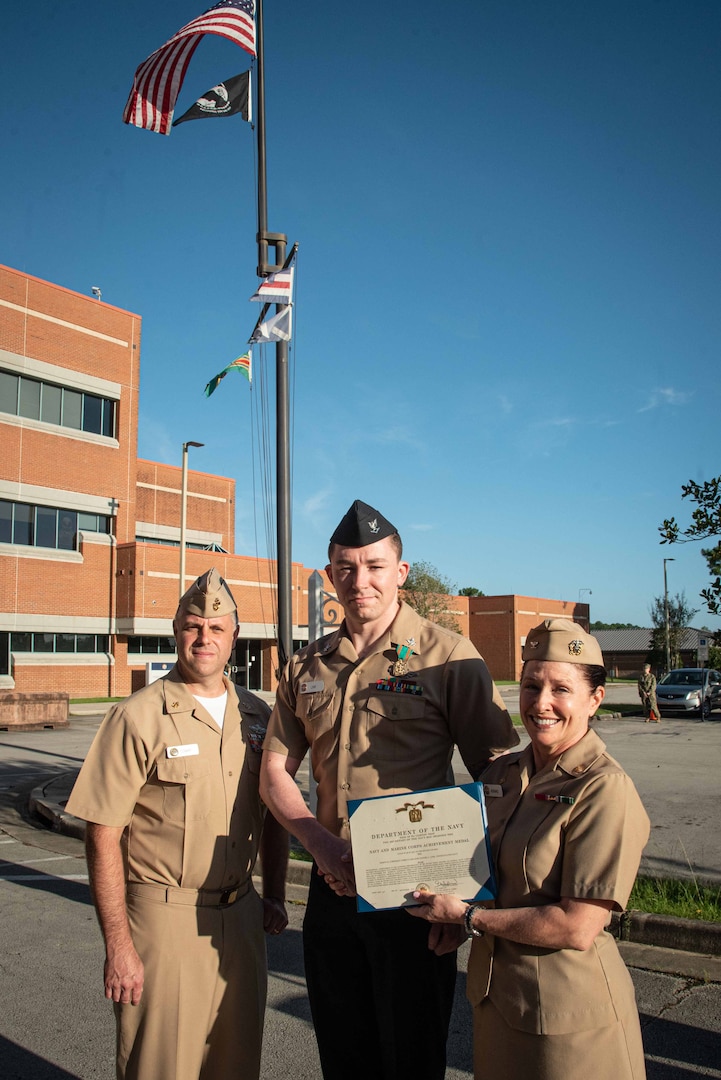 Hospital Corpsman Third Class Daniel Link receives the Navy and Marine Corps Achievement Medal for his service aboard Naval Health Clinic Cherry Point during a ceremony held Friday, September 9.